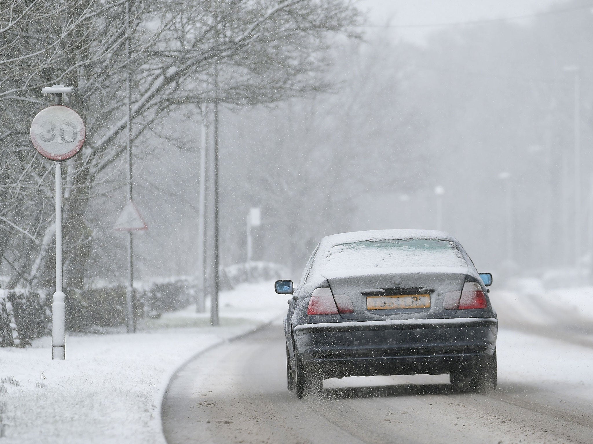A car makes its way through sleet and snow in Buxton, Derbyshire, on Sunday 22 February