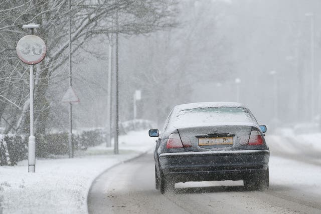 A car makes its way through sleet and snow in Buxton, Derbyshire, on Sunday 22 February