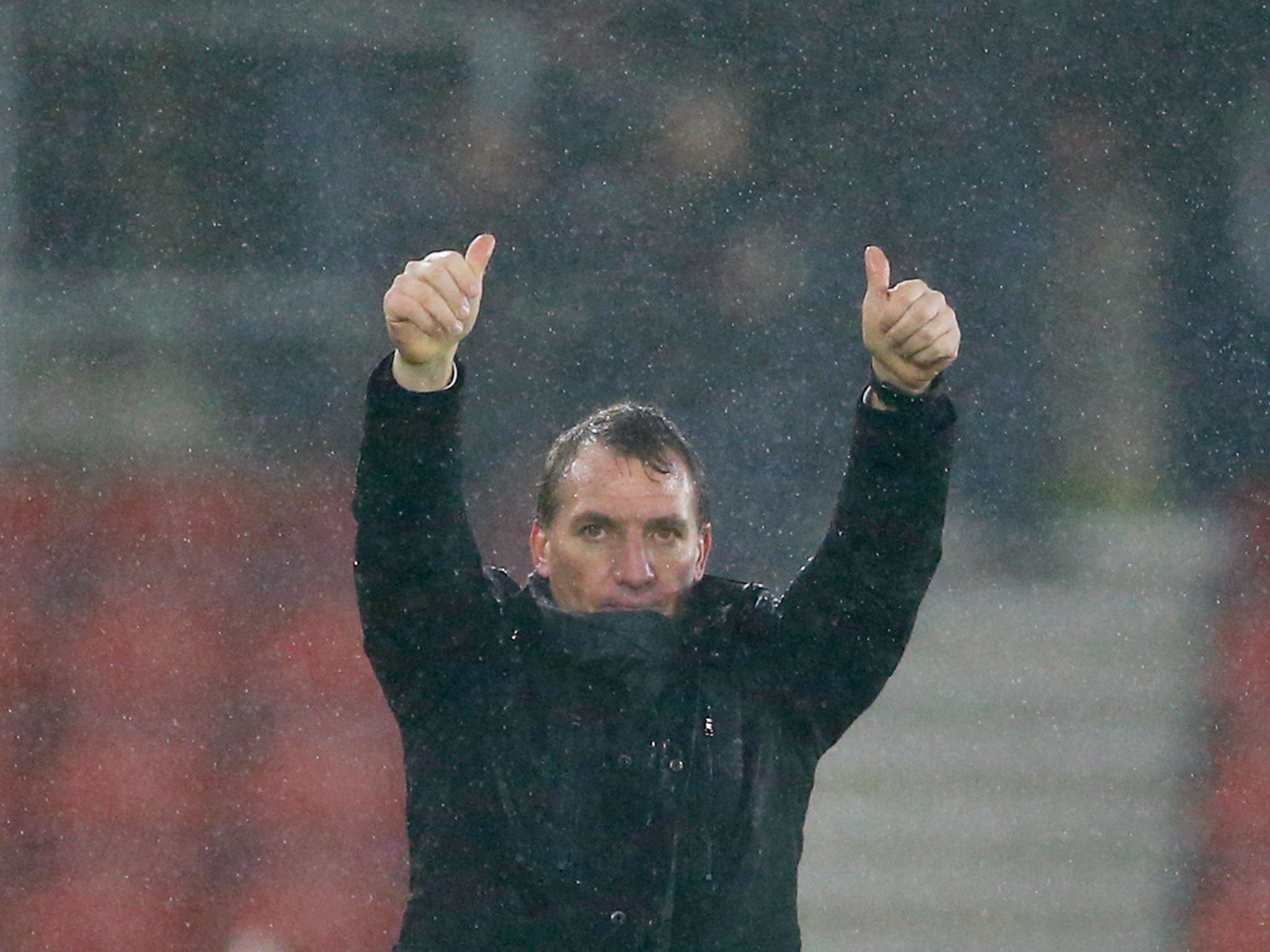 A soaked Brendan Rodgers signals his thanks to the Liverpool fans at St Mary’s