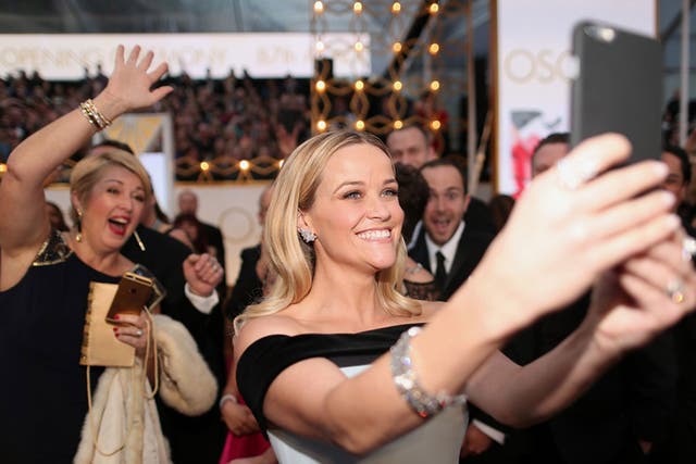 Best Actress nominee Reese Witherspoon taking a selfie on the red carpet
