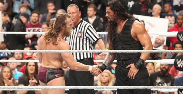 Daniel Bryan shakes hands with Roman Reigns after their fight