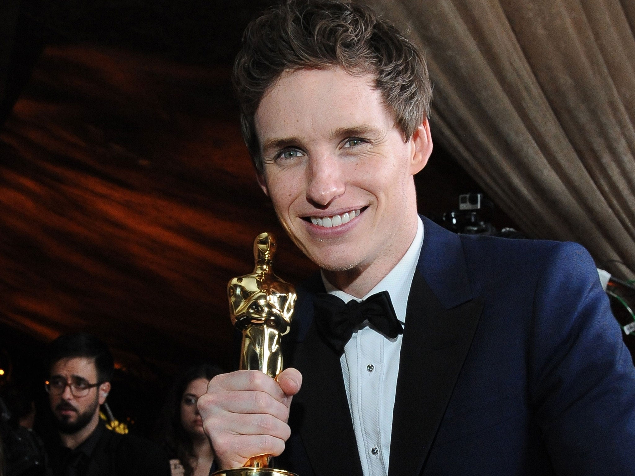 Eddie Redmayne clutches his Oscar for Best Actor