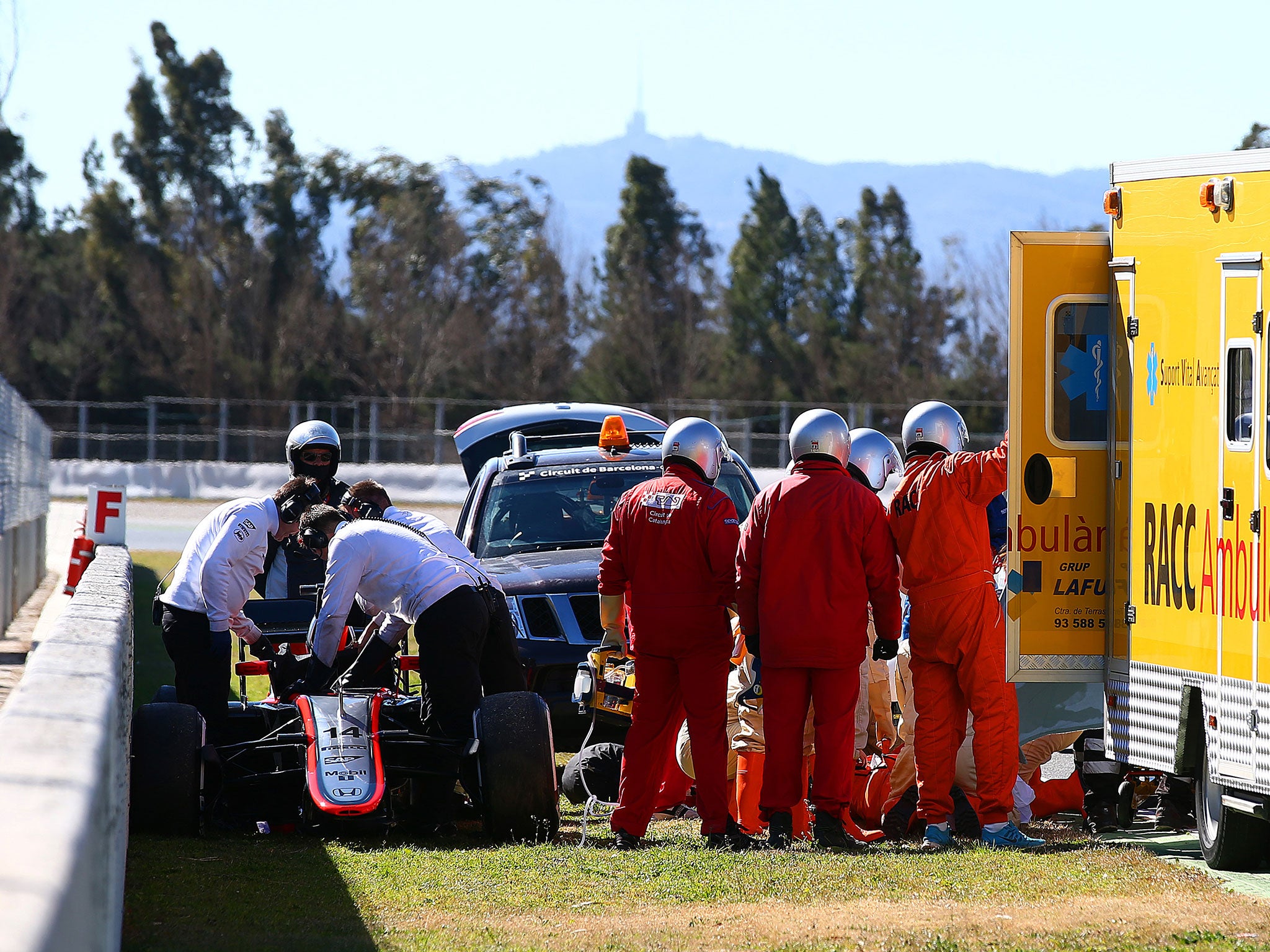 Alonso is taken form his stricken McLaren-Honda to an ambulance