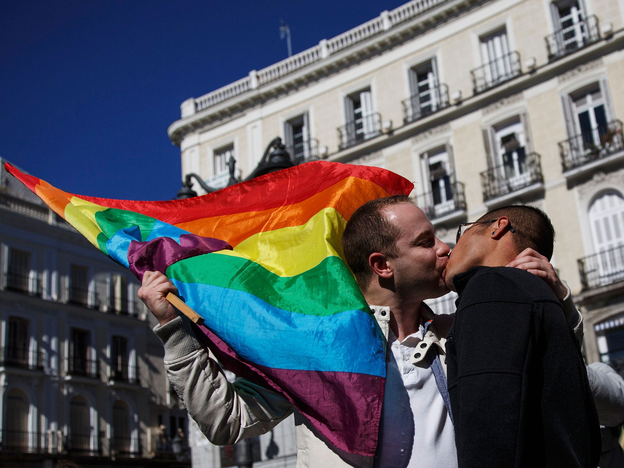 Men stage a kiss protest in front of a central metro station in Madrid. The protest was aimed against a leaked email which apparently urged metro workers to check the tickets of "musicians, beggars and gays" more often than other travellers, according to