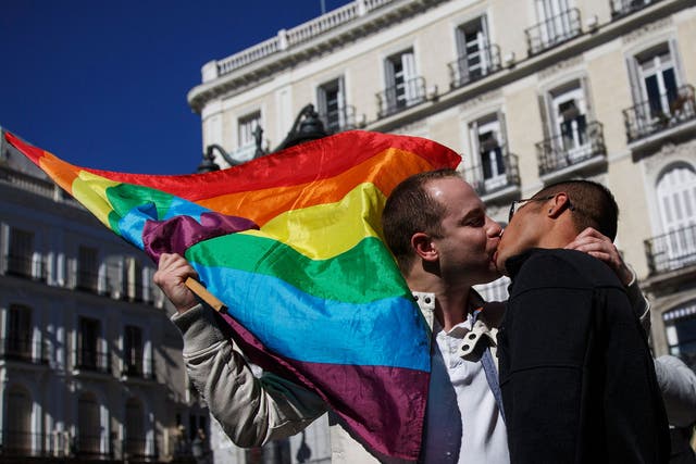 Men stage a kiss protest in front of a central metro station in Madrid. The protest was aimed against a leaked email which apparently urged metro workers to check the tickets of "musicians, beggars and gays" more often than other travellers, according to 