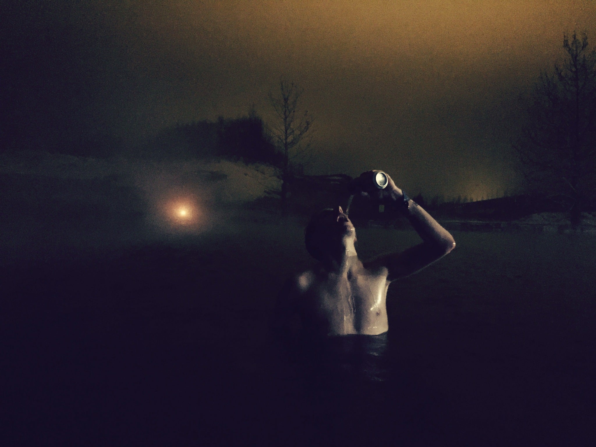 Me chugging a beer in the Secret Lagoon (Picture: Christopher Hooton)