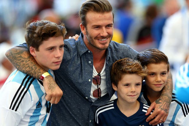 David Beckham poses with his three sons Brooklyn