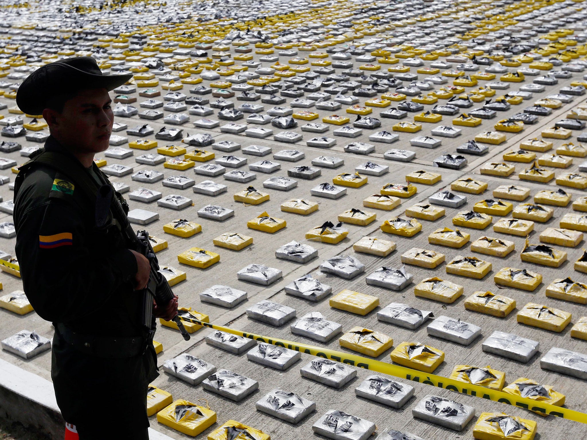 A counter-narcotic police stands guard packages of seized cocaine at the police station as it are show to the media in Necocli