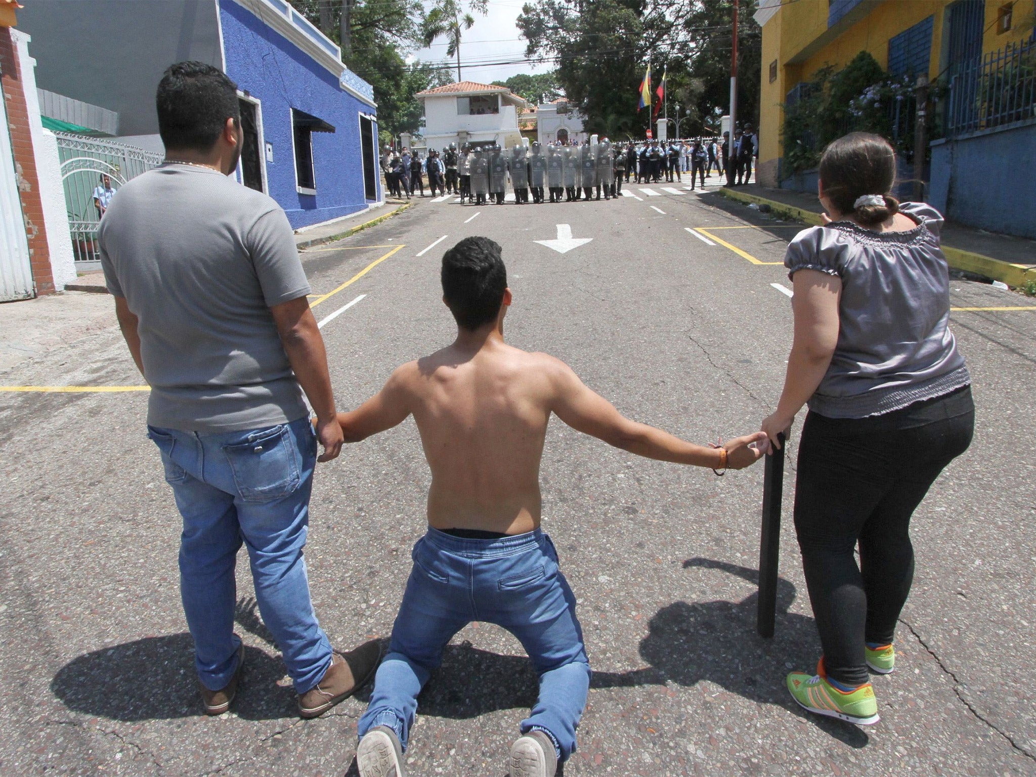 Anti-government protesters on the streets of San Cristobal on Tuesday during demonstrations in which a 14-year-old boy died after being shot in the head by a policeman