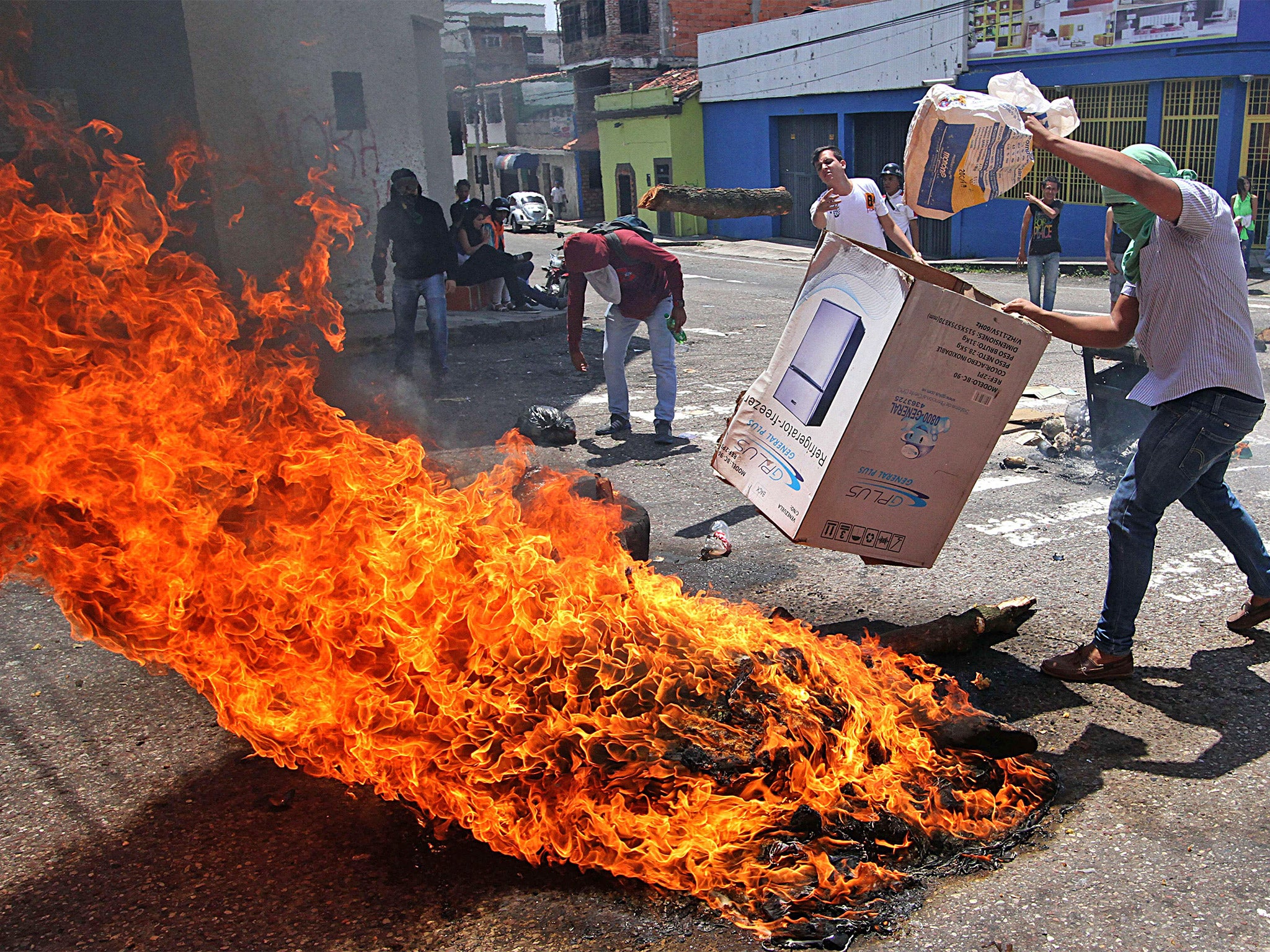 A group of students burn tyres during a protest against the Venezuelan government, in San Cristobal, on Tuesday (Getty)