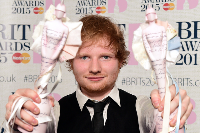 Ed Sheeran shows off his awards at the Brit Awards 2015