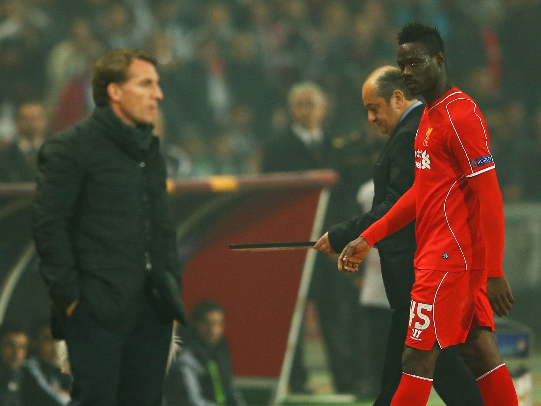 Balotelli glances across to manager Brendan Rodgers as he is subbed last week