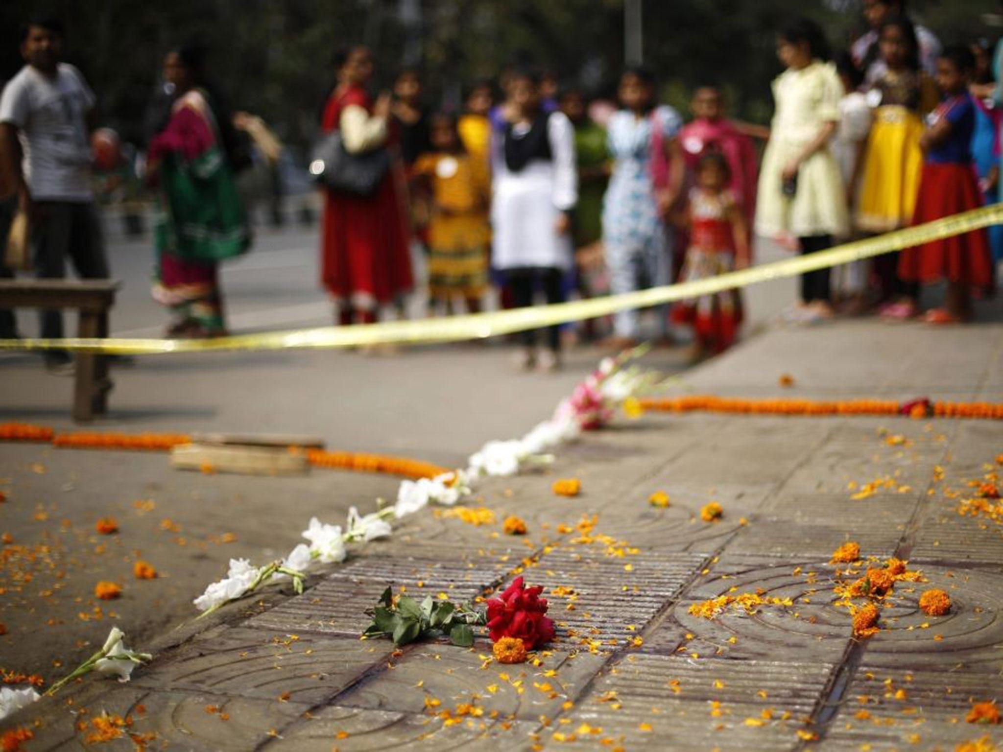 People gather on the spot where Bangladeshi blogger Avijit Roy was killed in a street in Dhaka
