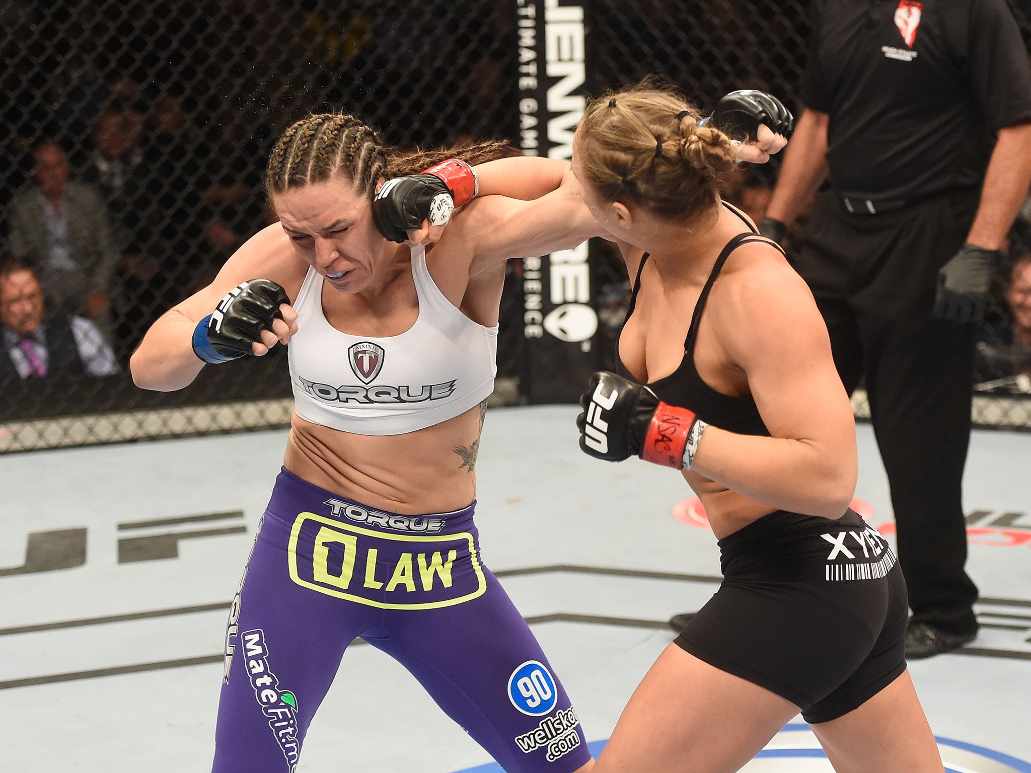 UFC bantamweight Champion Ronda Rousey punches Alexis Davis