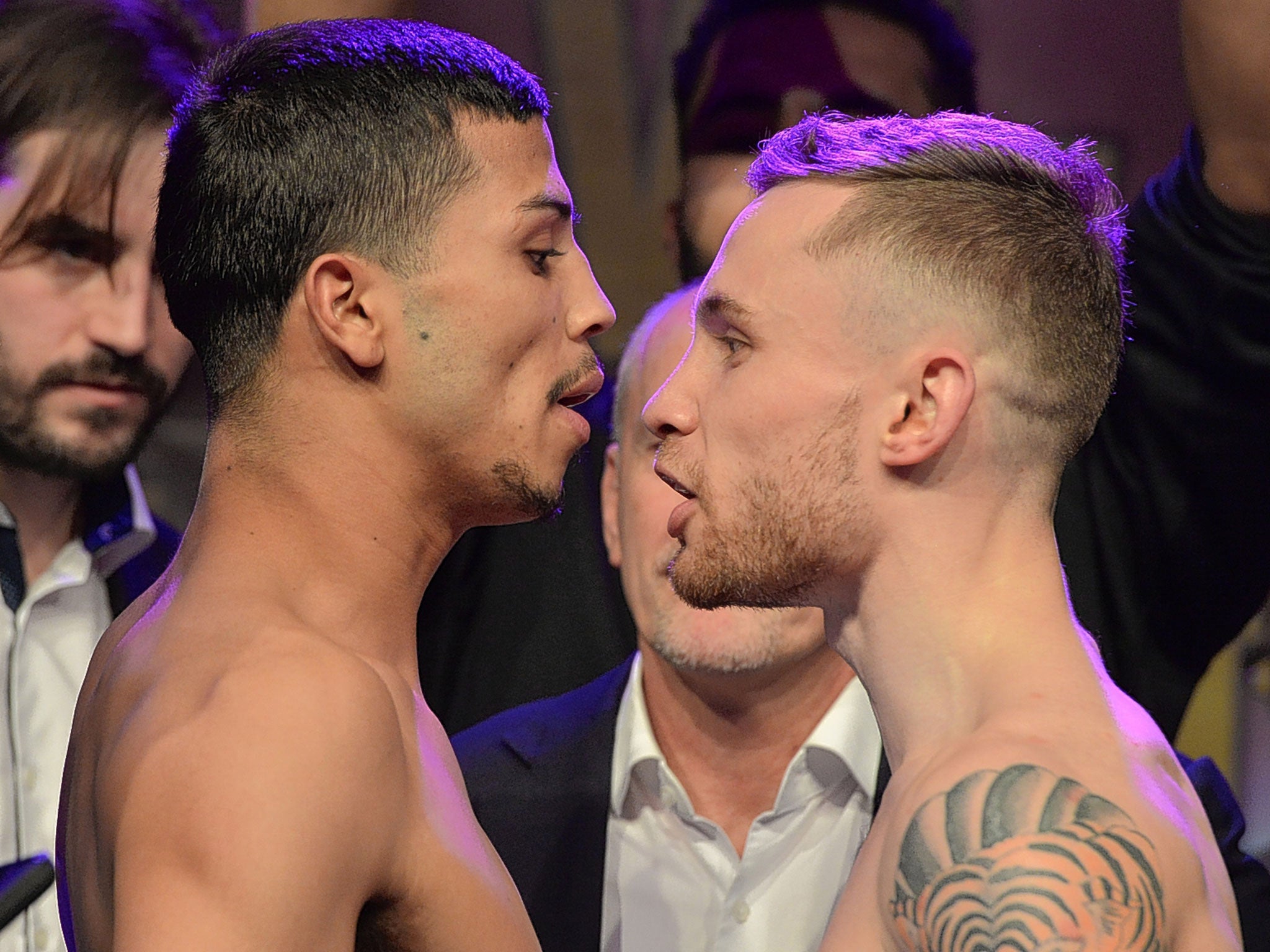 Carl Frampton (right) and Chris Avalos face off at their fiery pre-fight weigh-in on Friday in Belfast