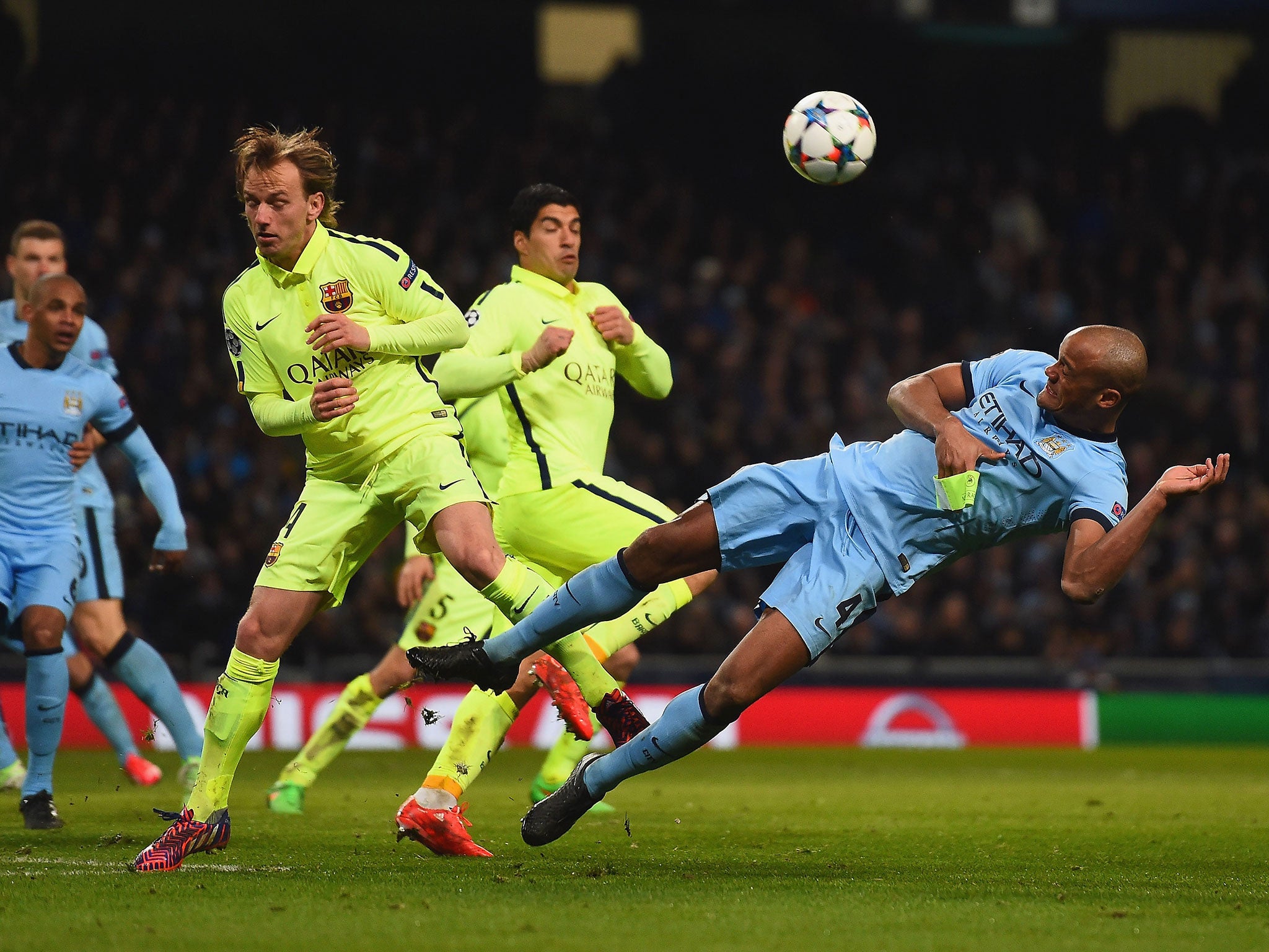 Vincent Kompany heads the ball clear during the defeat to Barcelona