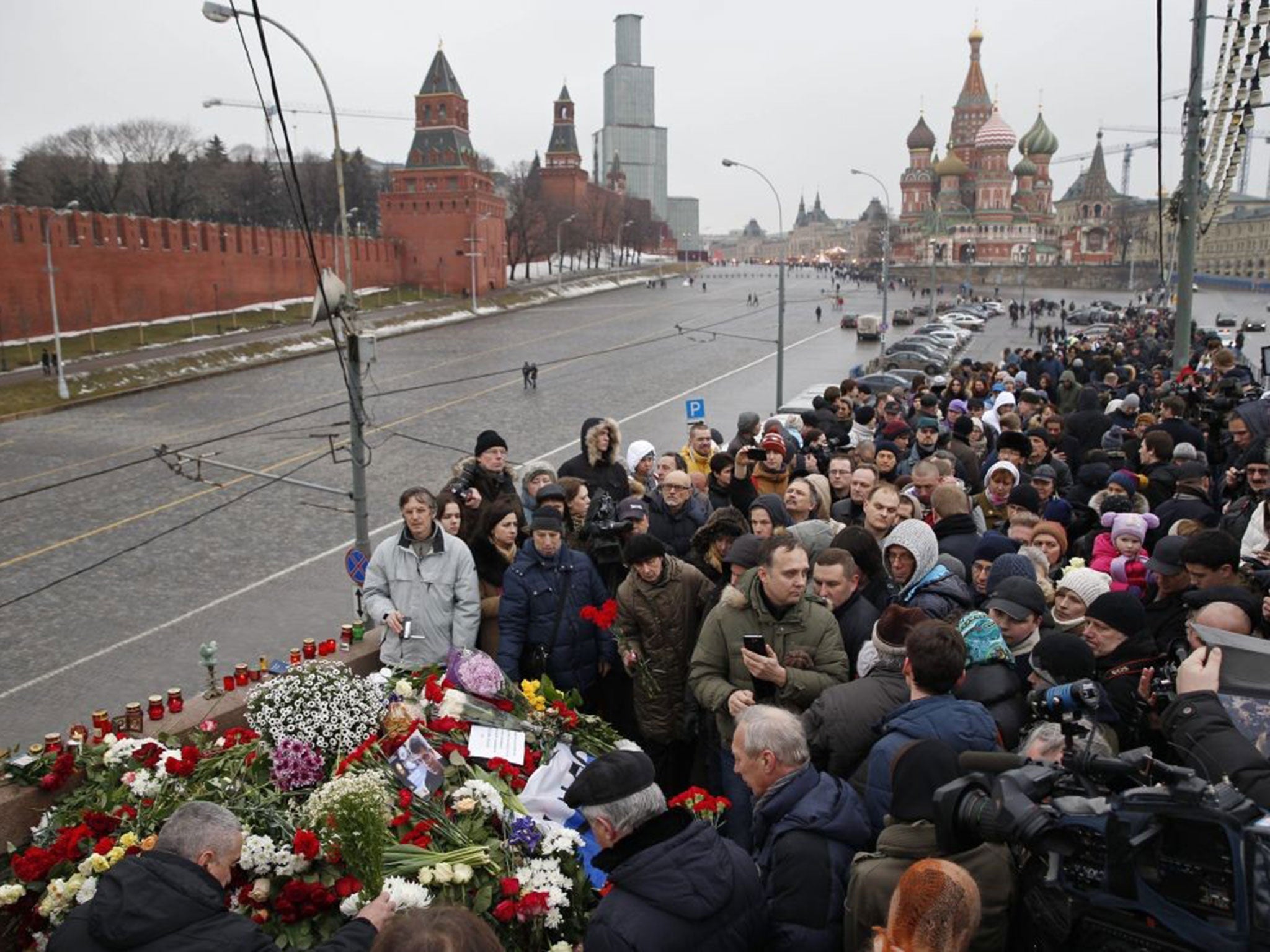 People lay flowers at the place where Boris Nemtsov was gunned down in Moscow