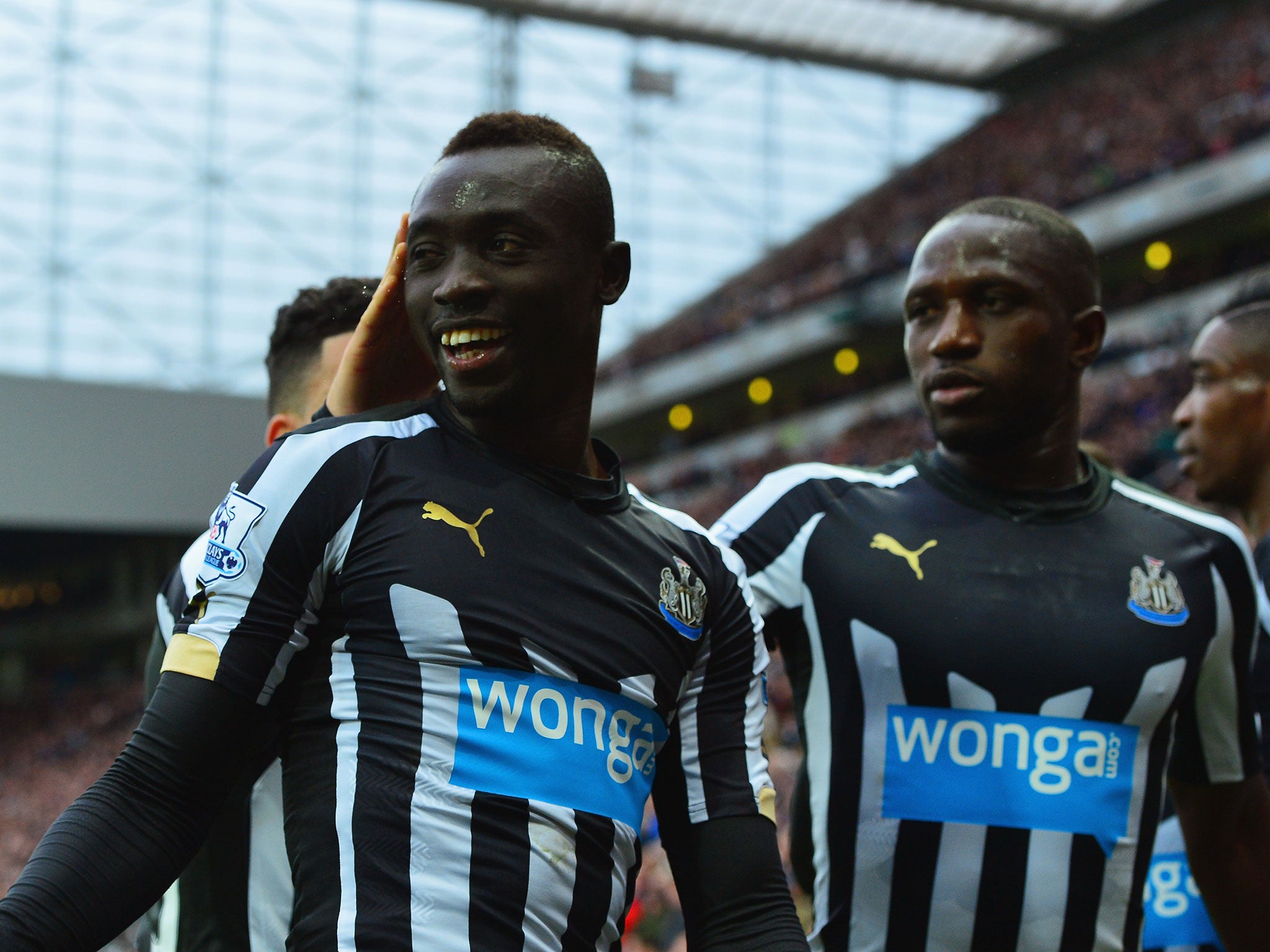 Cisse celebrates with his Newcastle team-mates