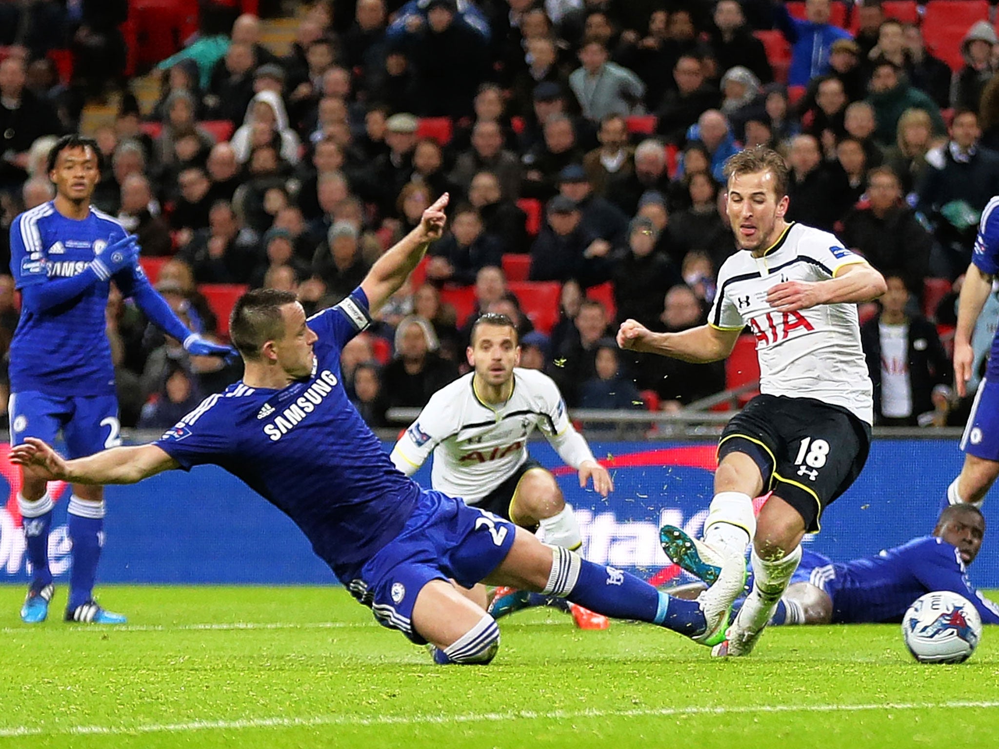 Harry Kane tries a rare shot for Spurs as John Terry slides in to snuff out the danger
