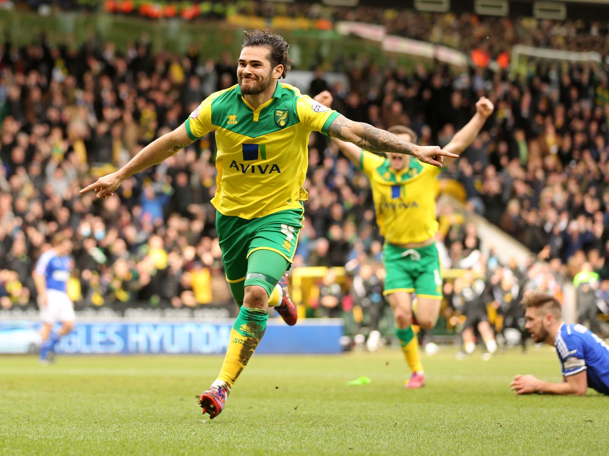 Bradley Johnson celebrates giving Norwich the lead in the derby against Ipswich at Carrow Road – his third goal in four games
