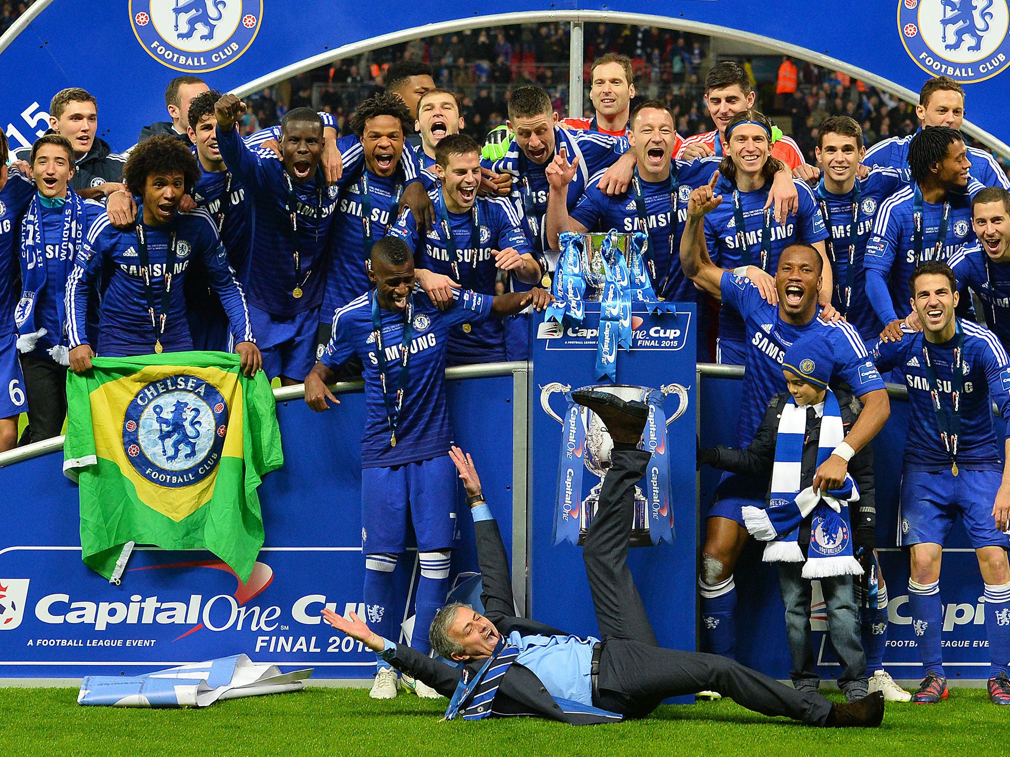Jose Mourinho takes his success lying down as Chelsea celebrate the first trophy of his second spell at Stamford Bridge