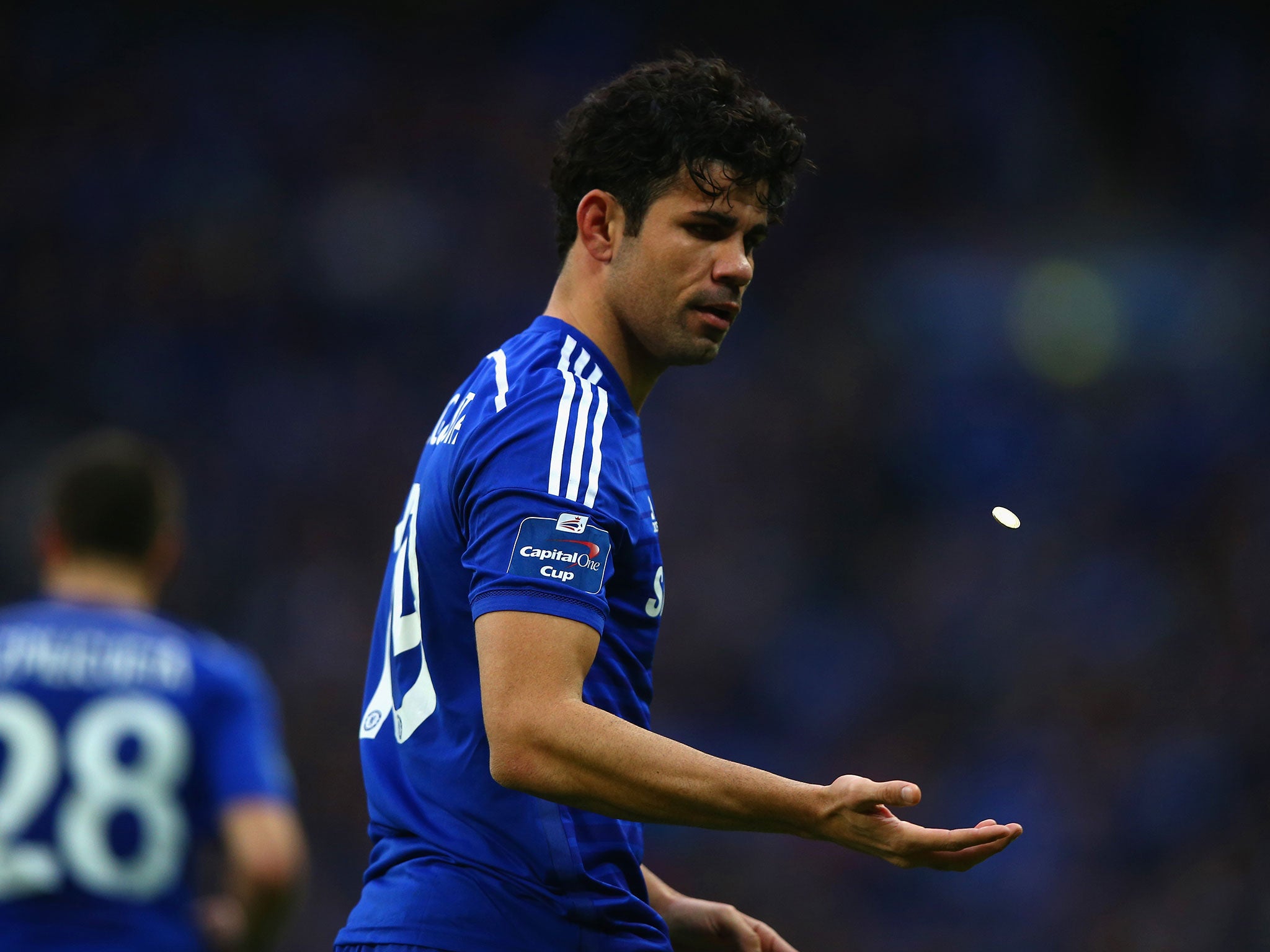 Diego Costa throws the coin up in the air