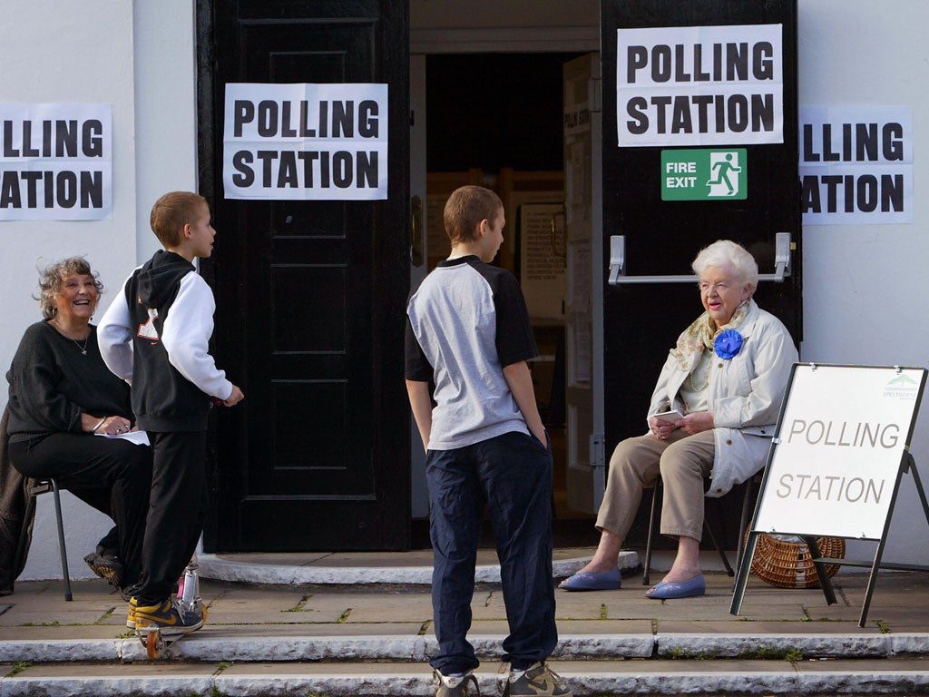 Teenagers make a request to vote at a polling station in Stanwell Village, west of London in the 2005 General Election