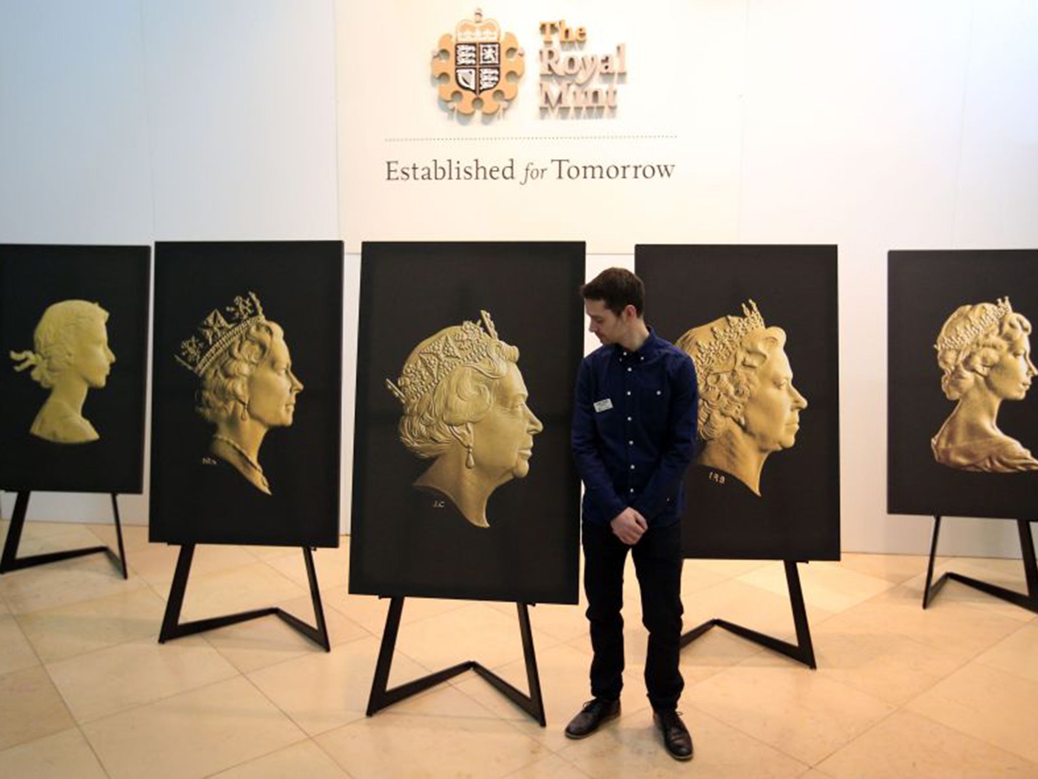 The Royal Mint Engraver Jody Clark with his new coinage portrait, alongside the four previous incarnations