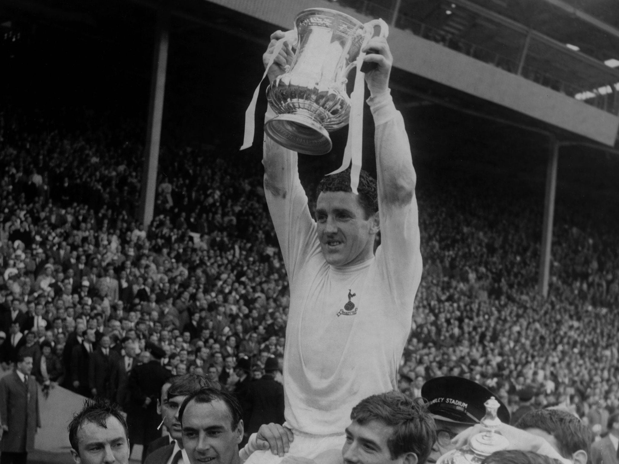 Dave Mackay lifts the FA Cup in 1967 having skippered Spurs to victory