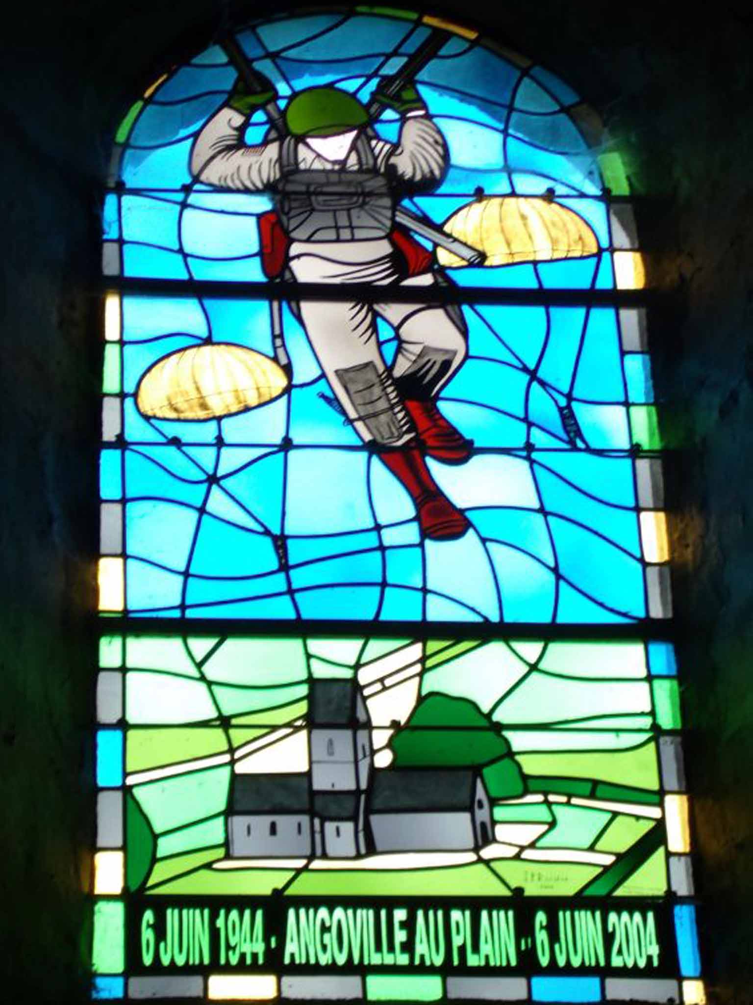 The stained glass window celebrating Kenneth Moore's exploits in the church at Angovilleau-Plain