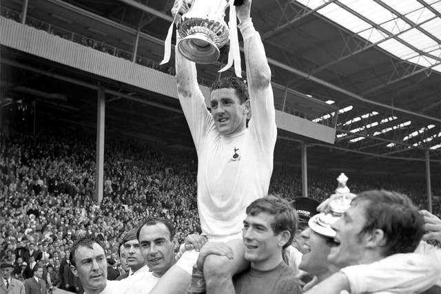 Dave Mackay holds the FA Cup trophy aloft following Tottenham Hotspur's victory in 1967