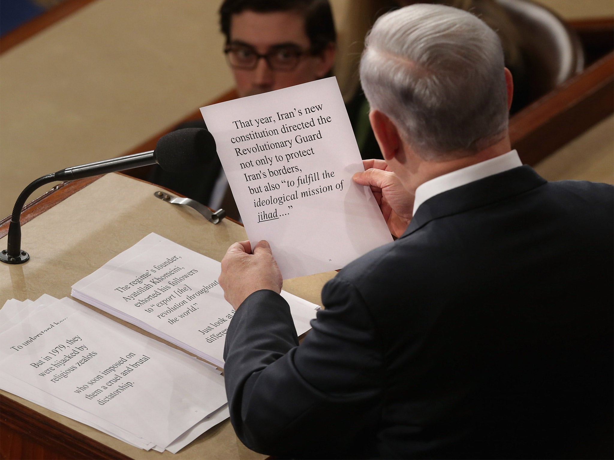 Israeli Prime Minister Benjamin Netanyahu takes a look at his notes as he addresses the United States Congress on Tuesday