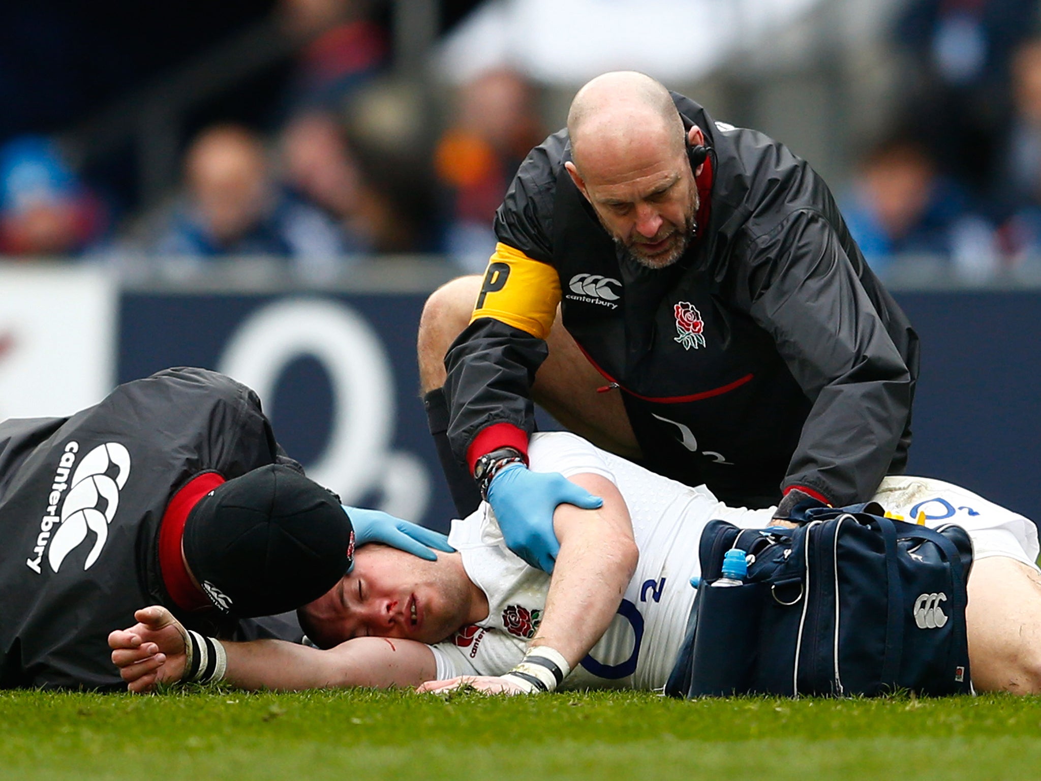 Mike Brown of England receives medical attention during the RBS Six Nations match between England and Italy at Twickenham