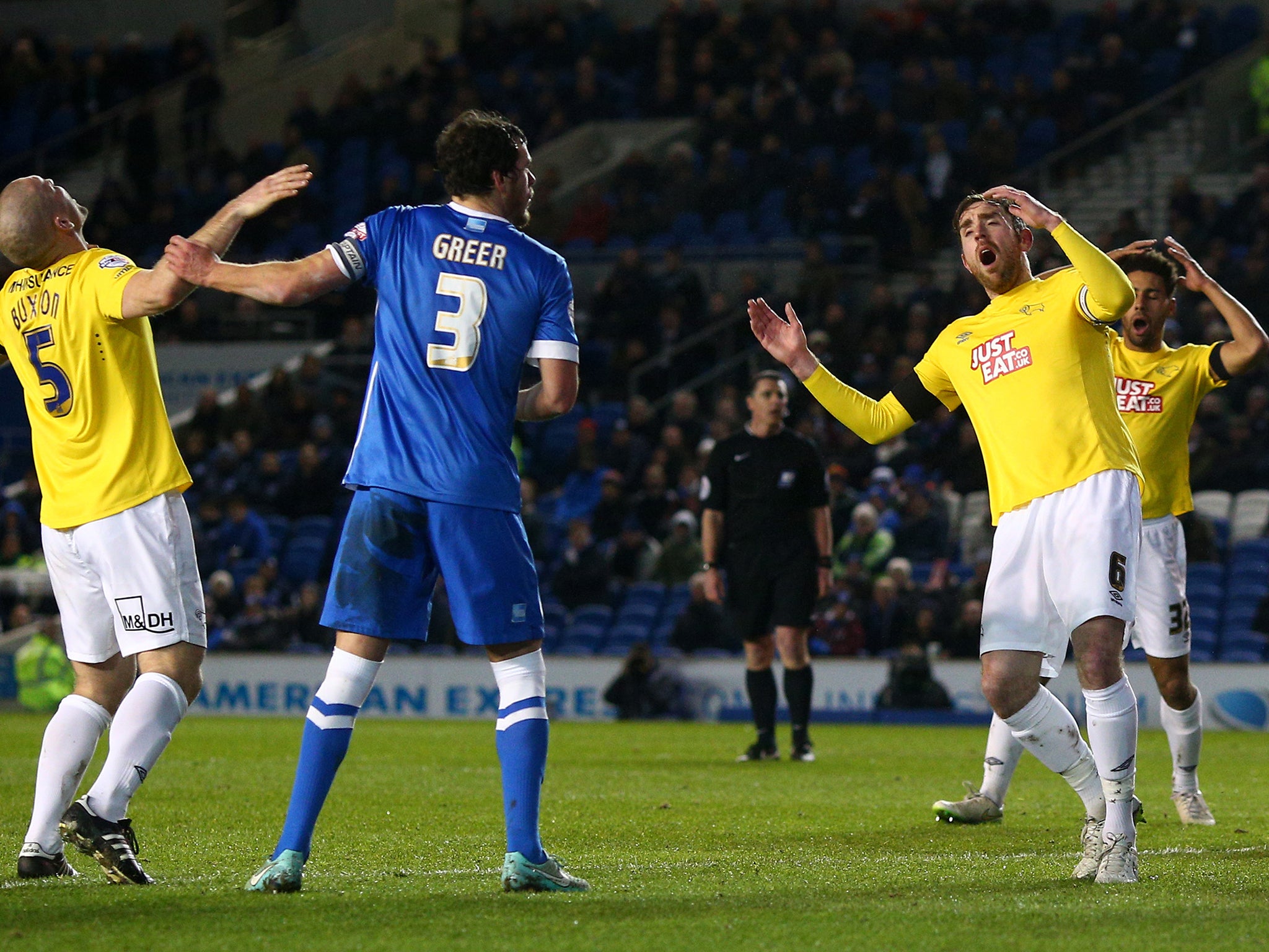 Derby players look dejected after Richard Keogh (C) goes close
