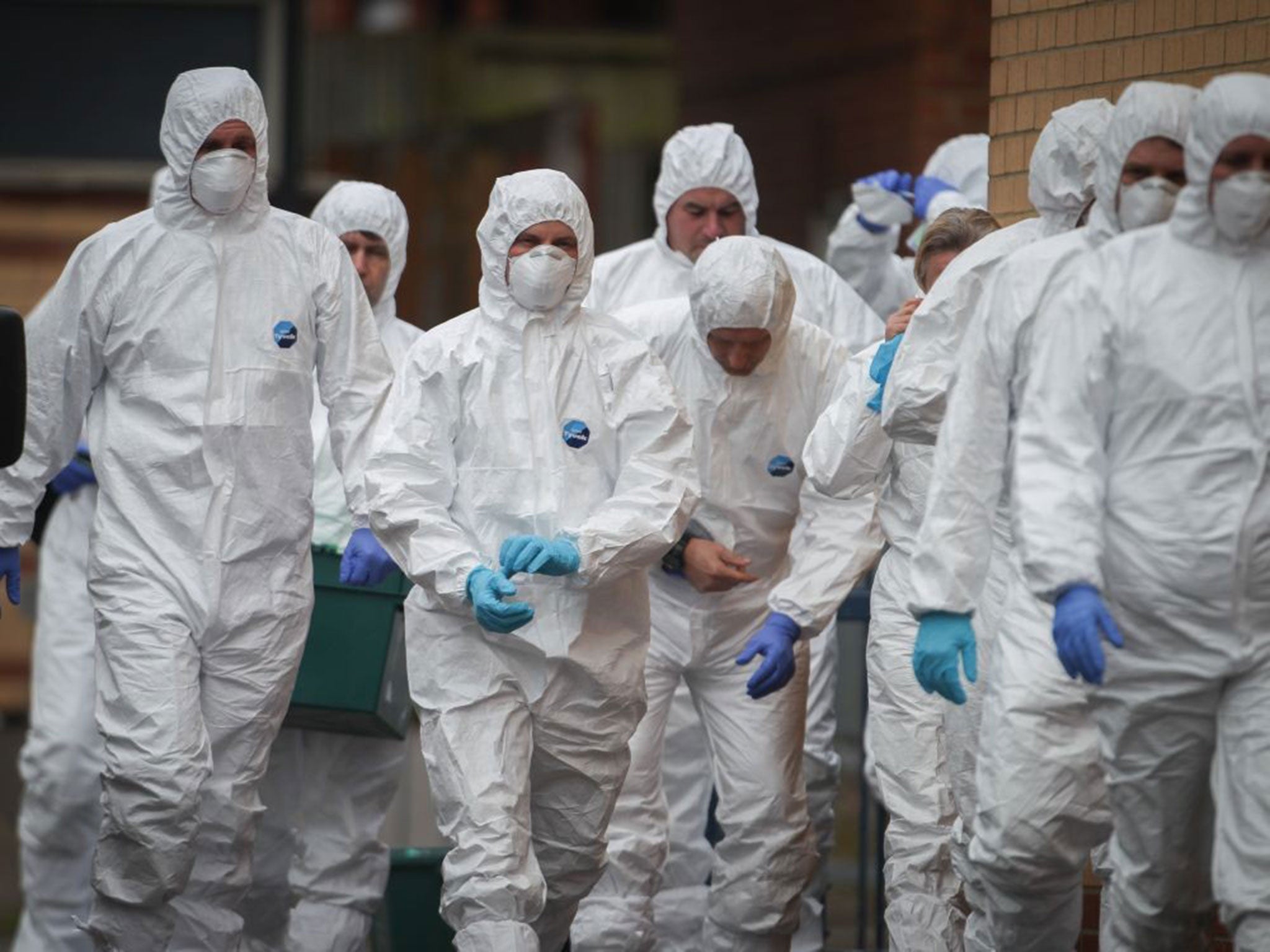 Police continue their investigations outside properties in Barton Court on March 3