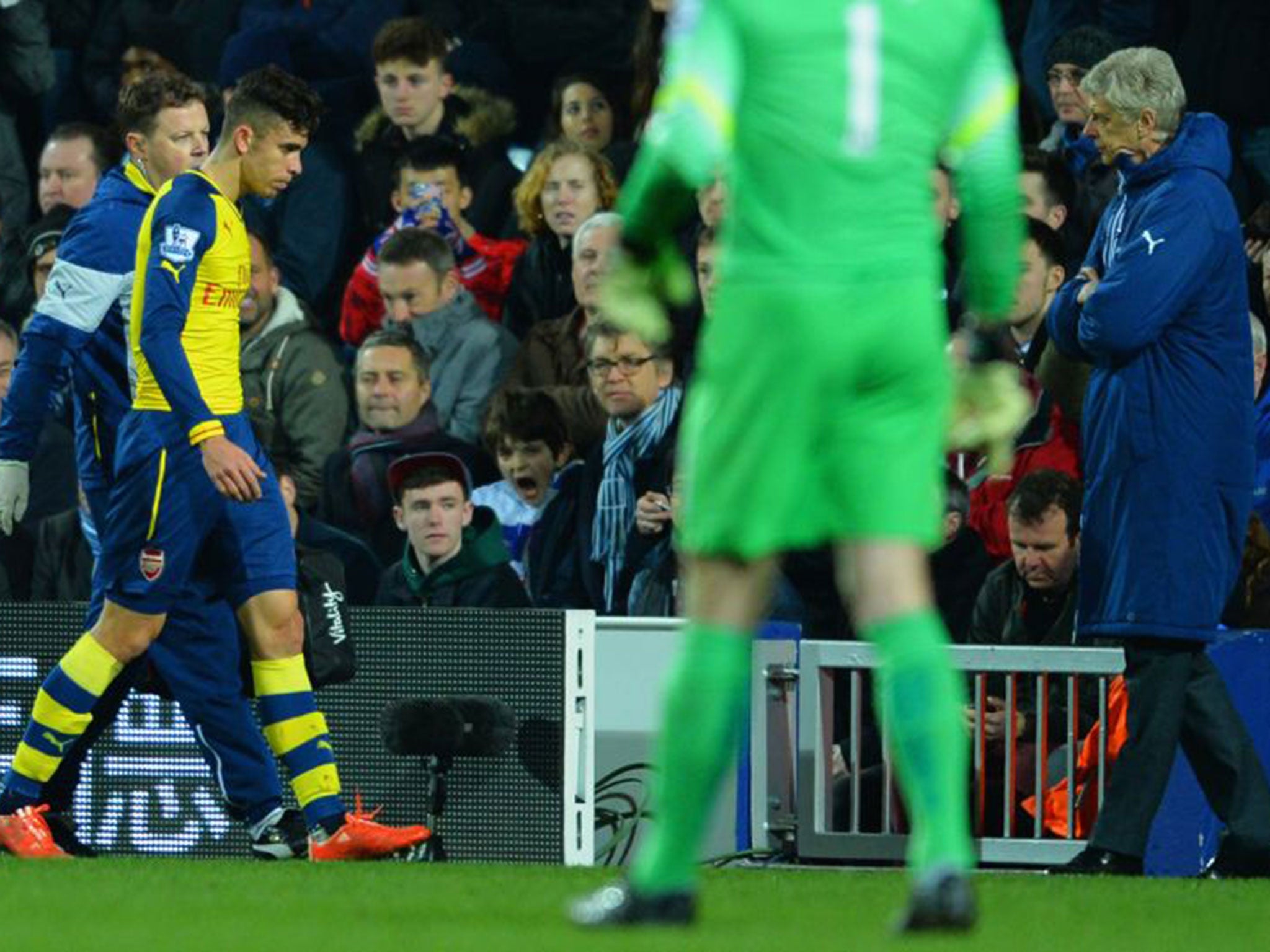 Gabriel is taken off with a hamstring injury. Arsenal manager Arsene Wenger looks on