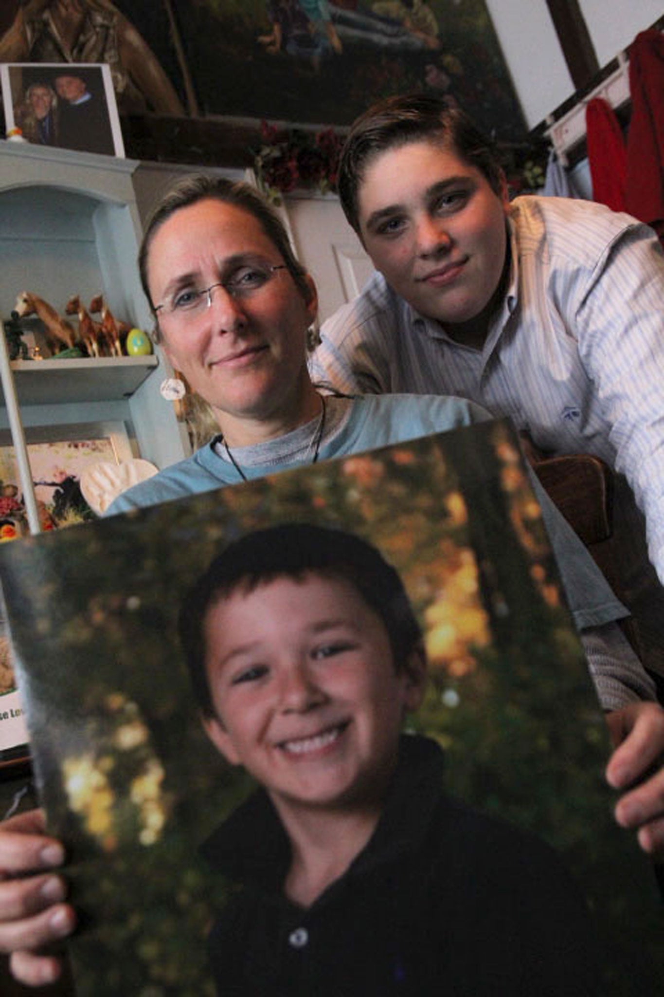 Scarlett Lewis holds up a photo of her six-year-old son Jesse, who was killed in the attack