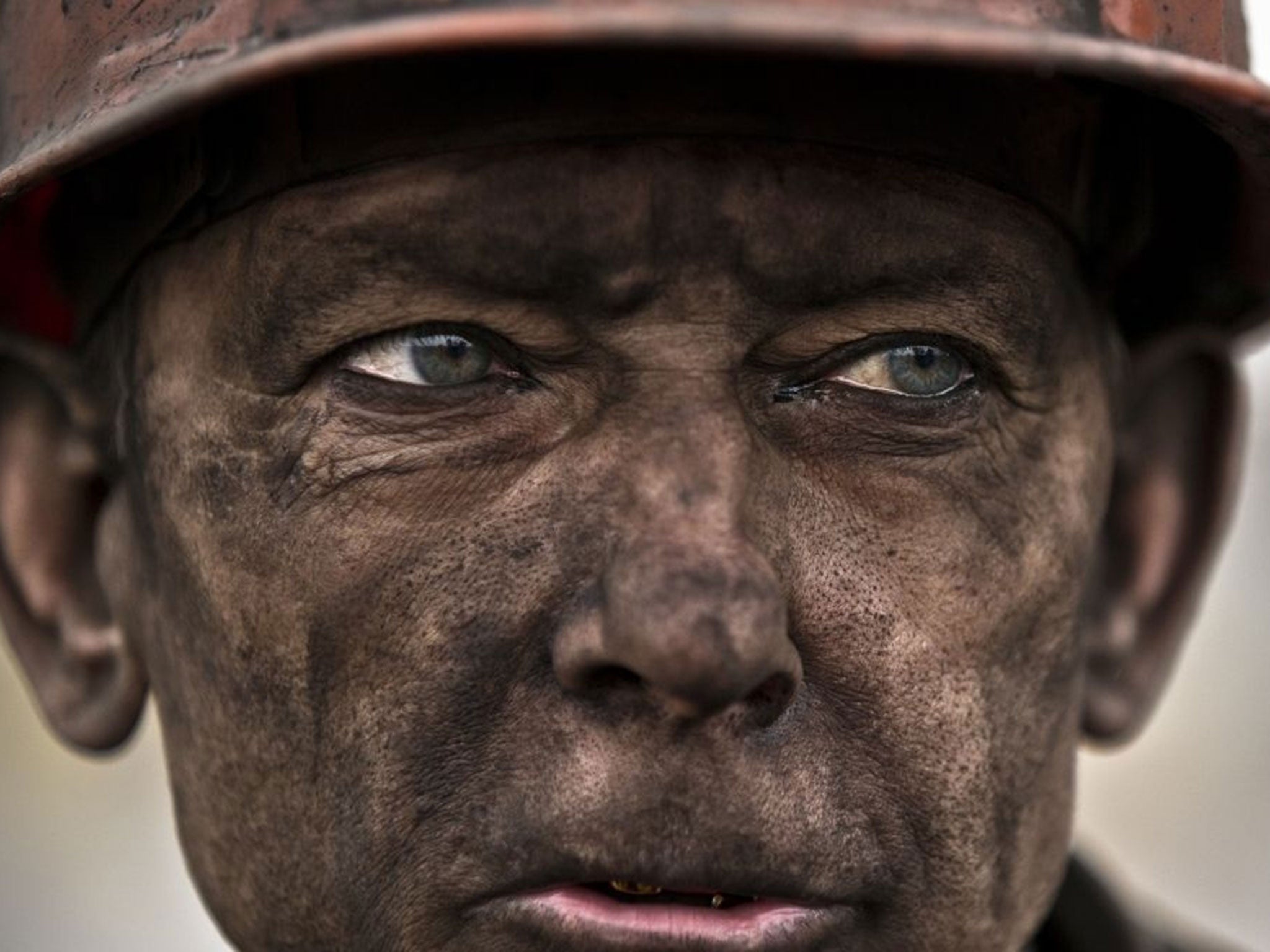 An Ukrainian coal miner at Zasyadko mine, where he helped search for bodies of colleagues and clear up debris (AP)