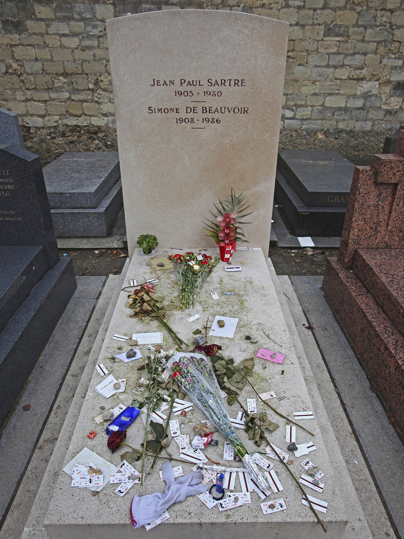 Beauvoir and Sartre’s grave in Montparnasse (Getty)