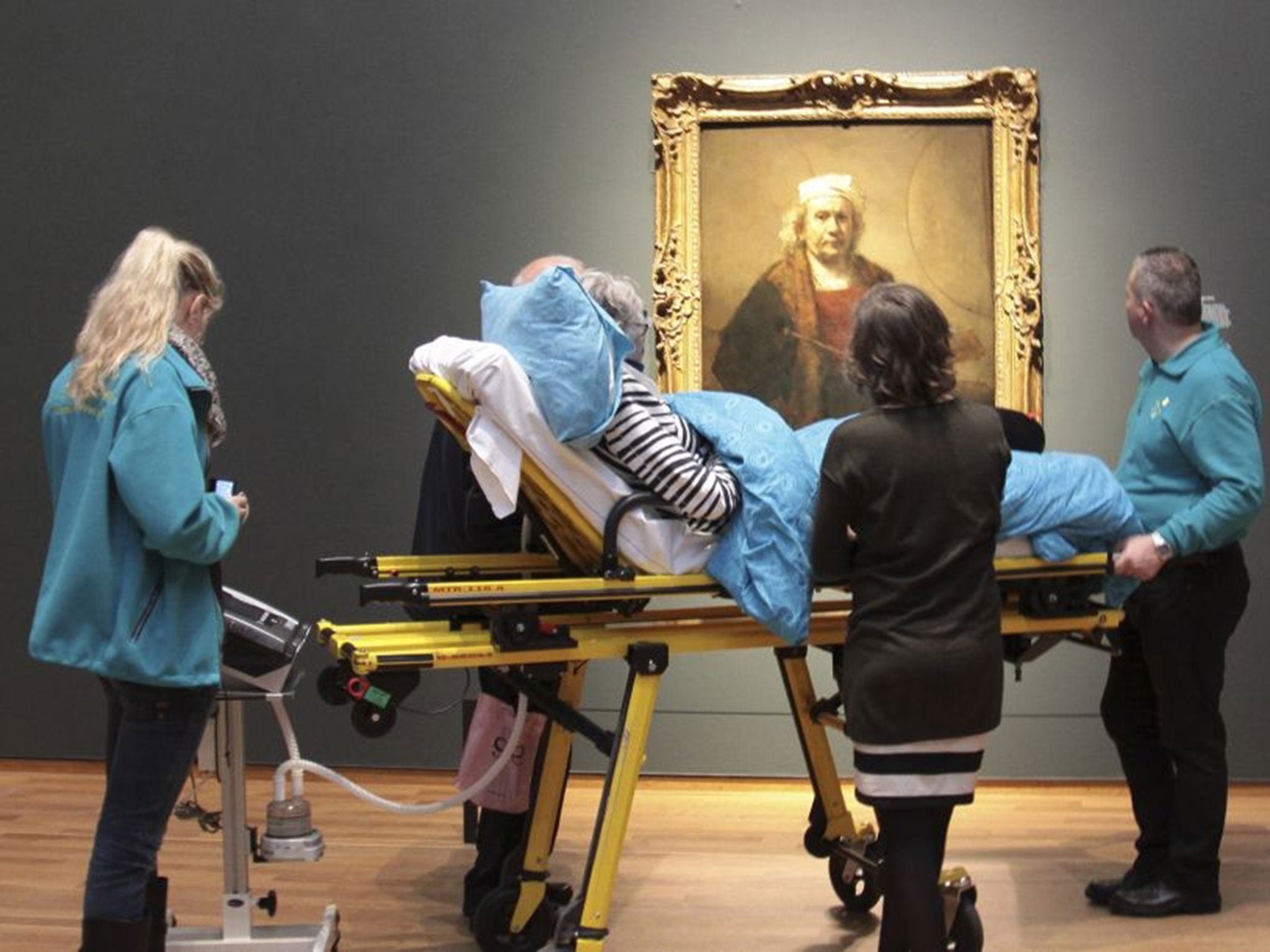 A terminally ill woman looks at a self portrait of Rembrandt at Amsterdam's Rijksmuseum