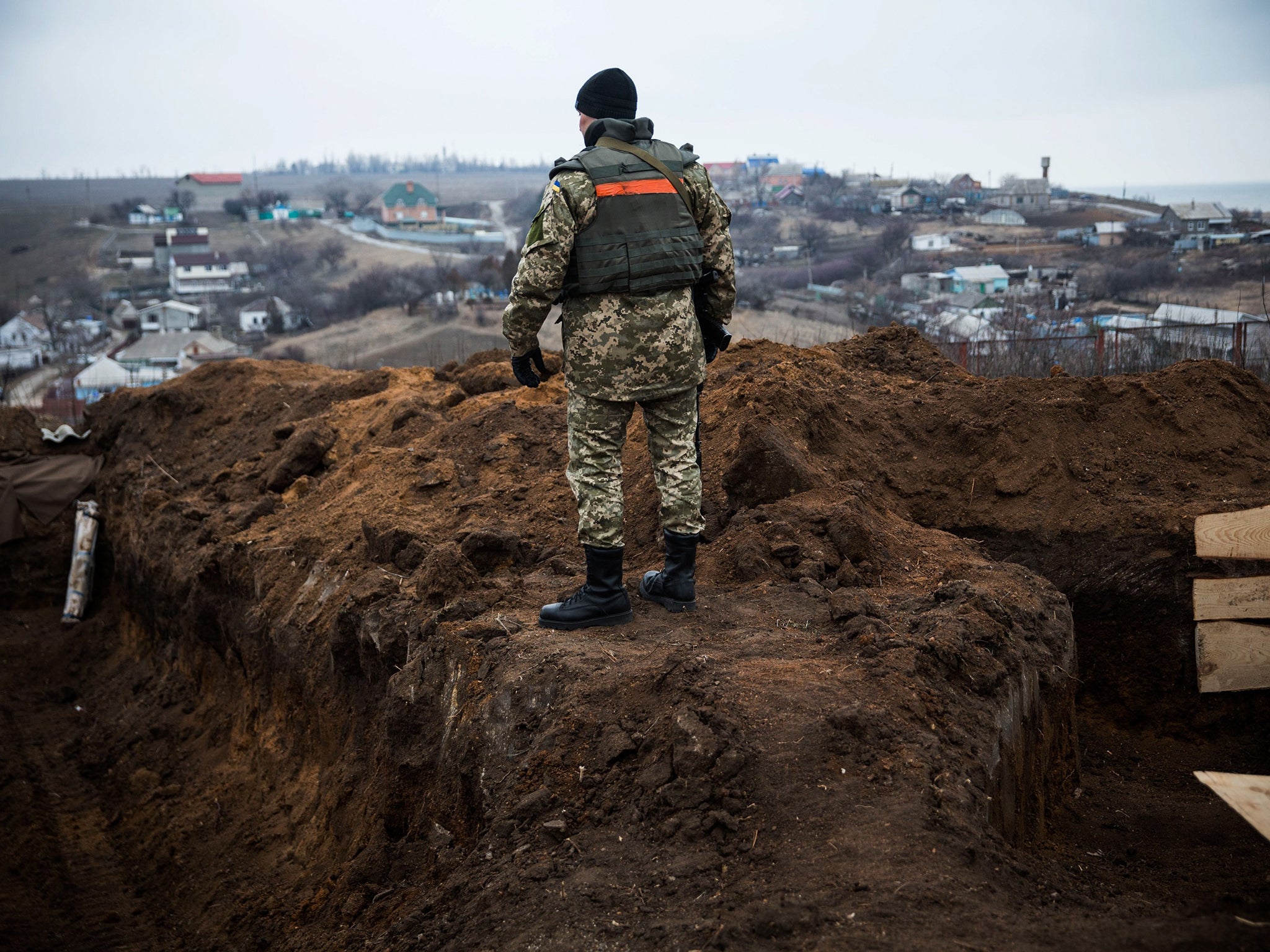 A Ukrainian soldier stands near the front line of defence against pro-Russian separatists near the village of Berdianske on the eastern side of Mariupol