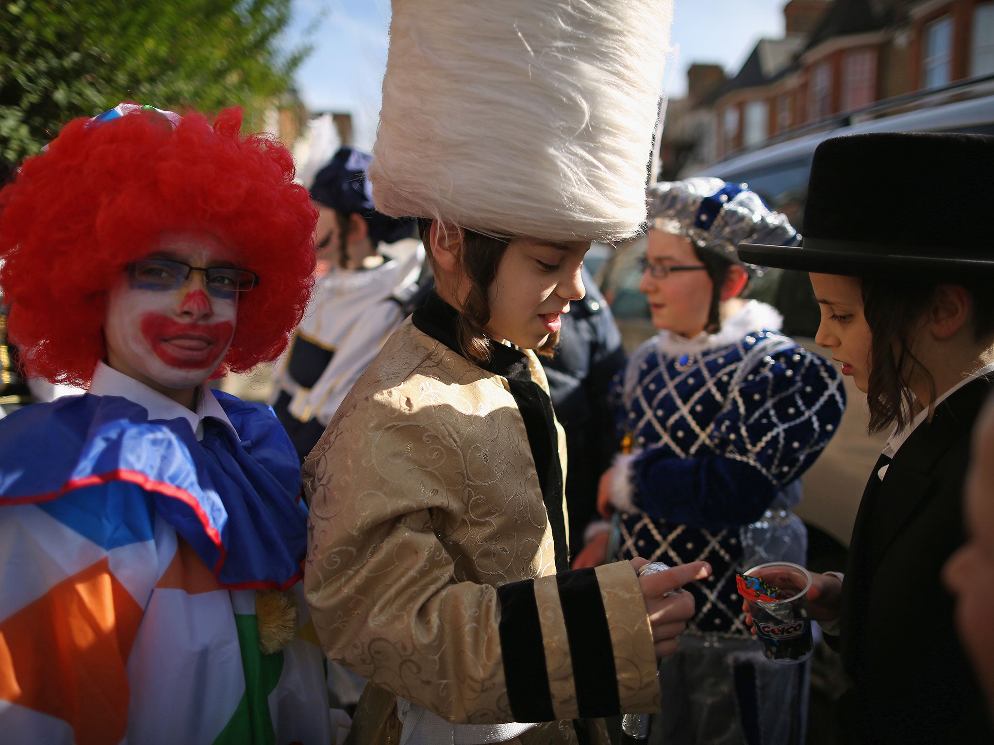 A group of Jewish girls in fancy dress walk through the streets collecting money for their school Purim. (Getty Images)