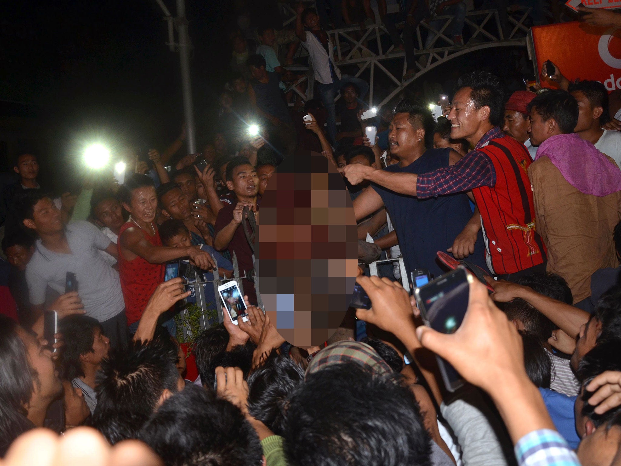 A crowd of Indian men surround an alleged rapist after he was dragged out of prison and beaten to death in Dimapur in the northeastern Indian state of Nagaland