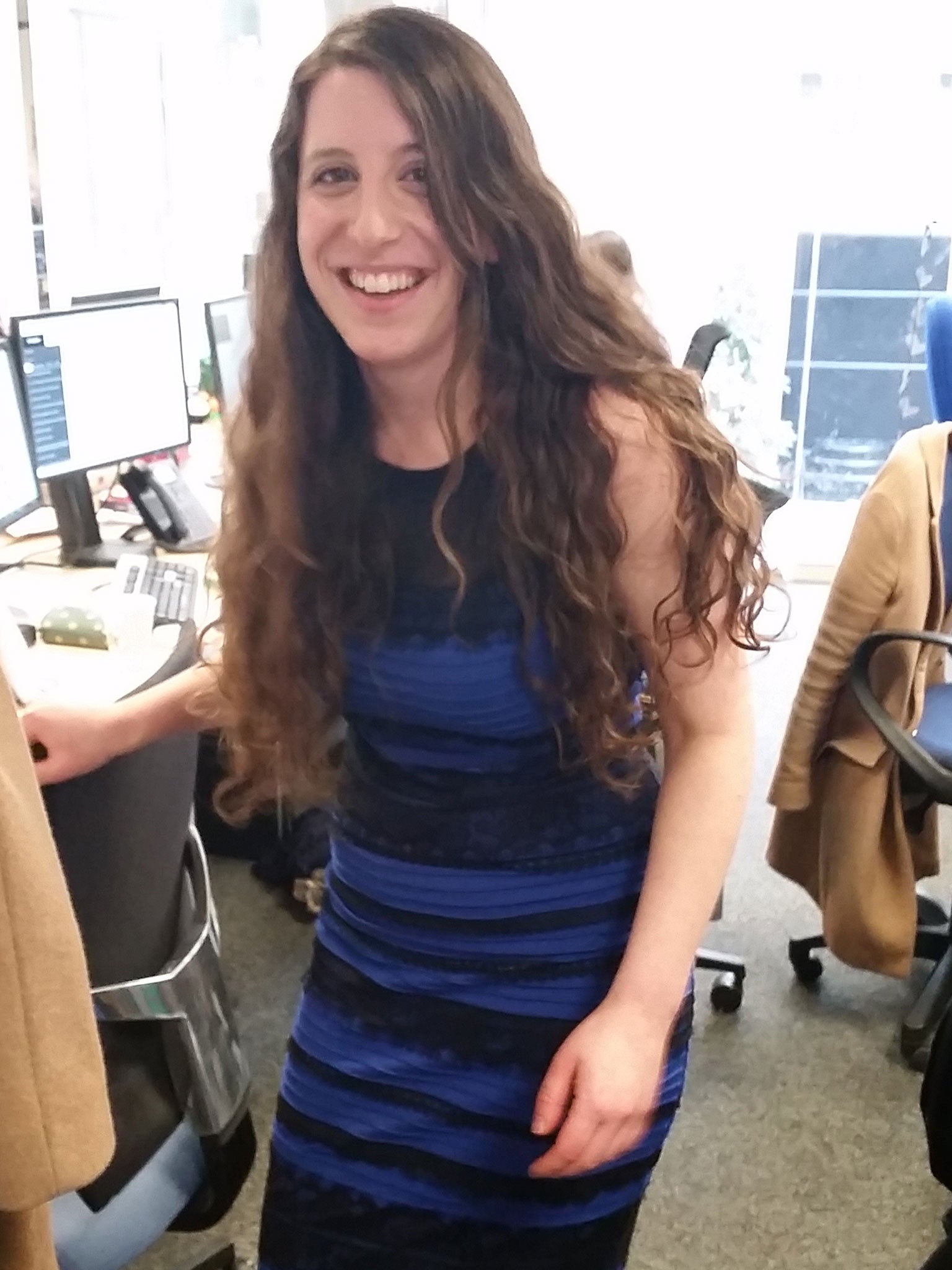 Dina Rickman tries the famous dress on in the office