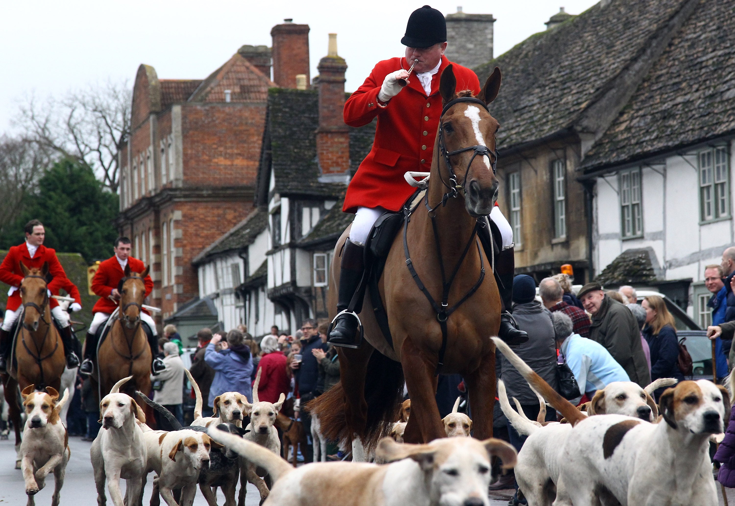 Fox hunters ride through the village of Lacock during a traditional Boxing Day Hunt in 2011