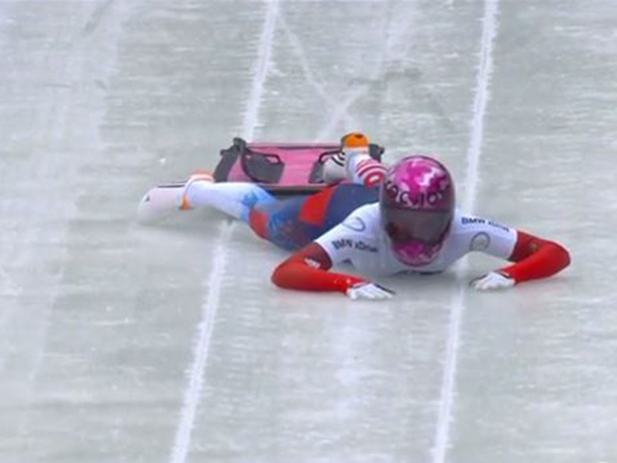 Elena Nikitina slides down the ice track after missing her skeleton sled