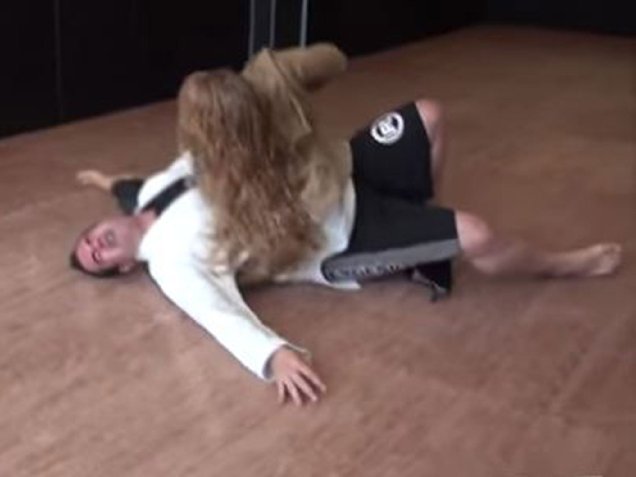 UFC champion Ronda Rousey throws presenter Aaron Tru to the floor