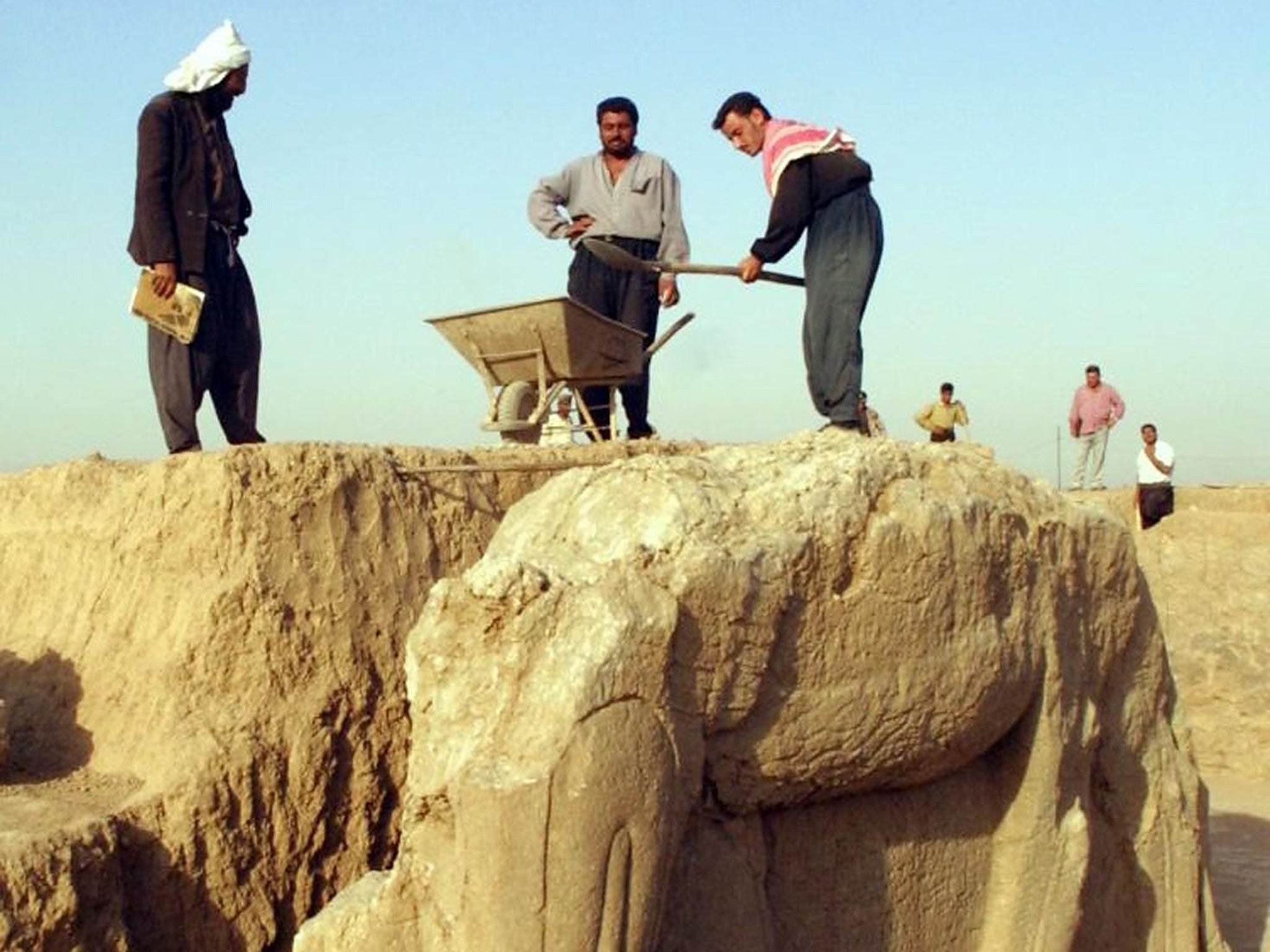 Isis militants have bulldozed the ancient city of Nimrud, pictured here undergoing maintenance in 2001