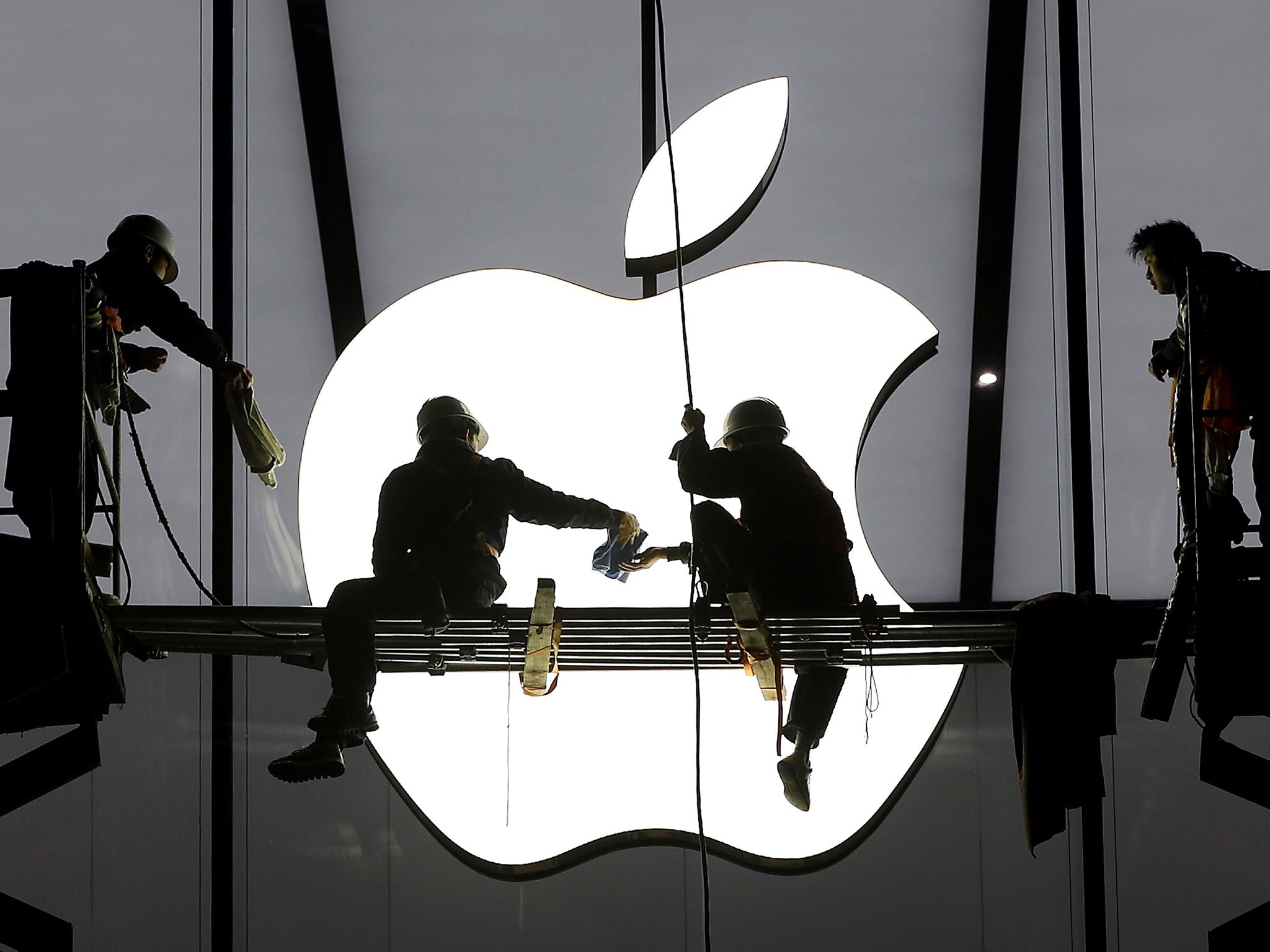 Workers prepare for the opening of an Apple Store in Hangzhou, China