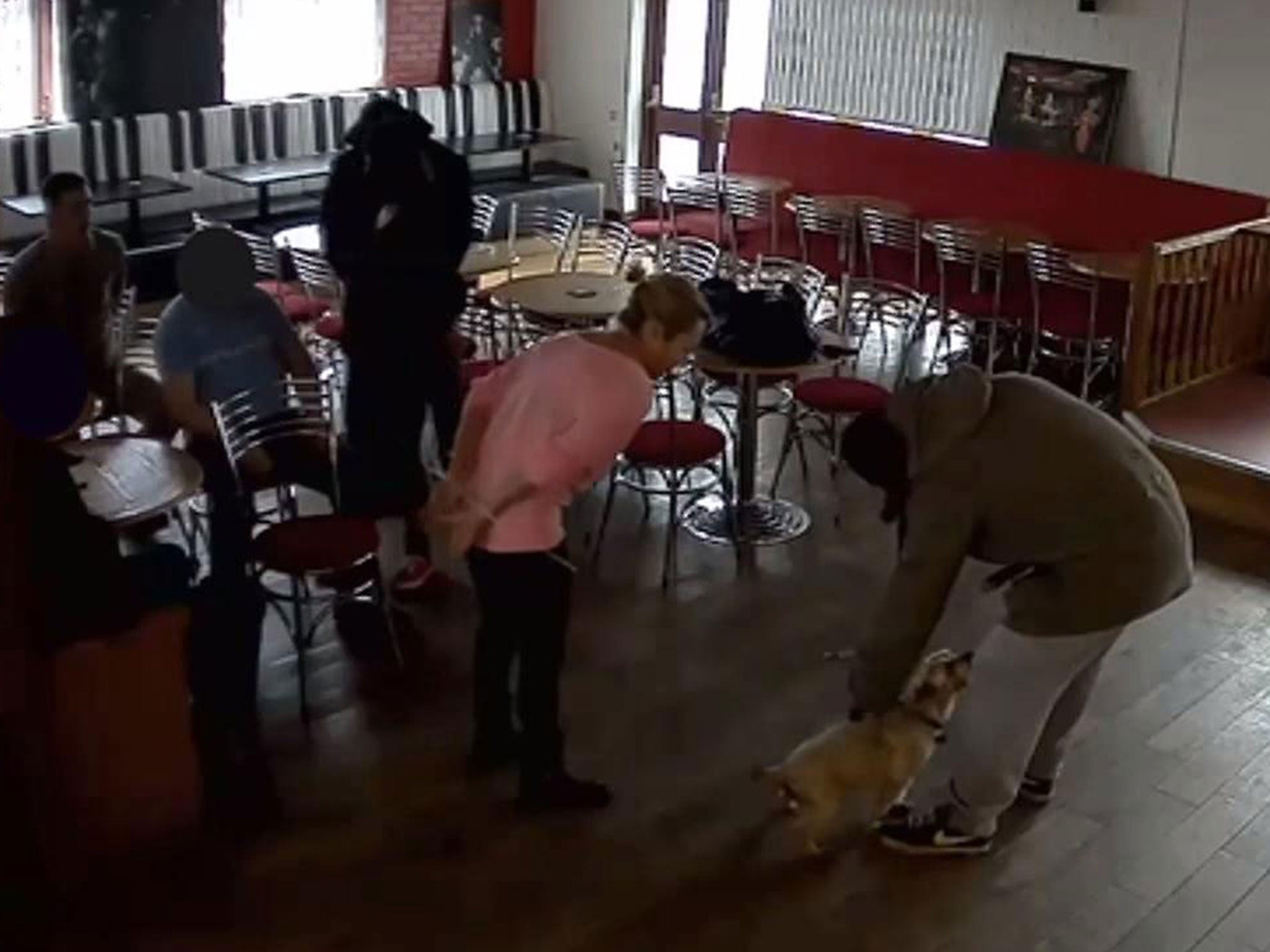 One of the robbers broke off to pet his hostage's dog at the Strawberry Duck pub in Manchester